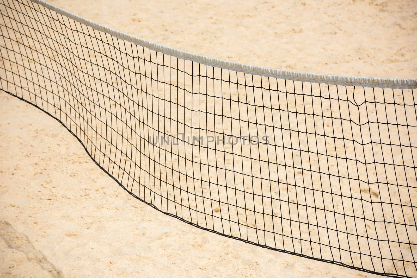 volleyball net on empty sand beach. horizontal shot