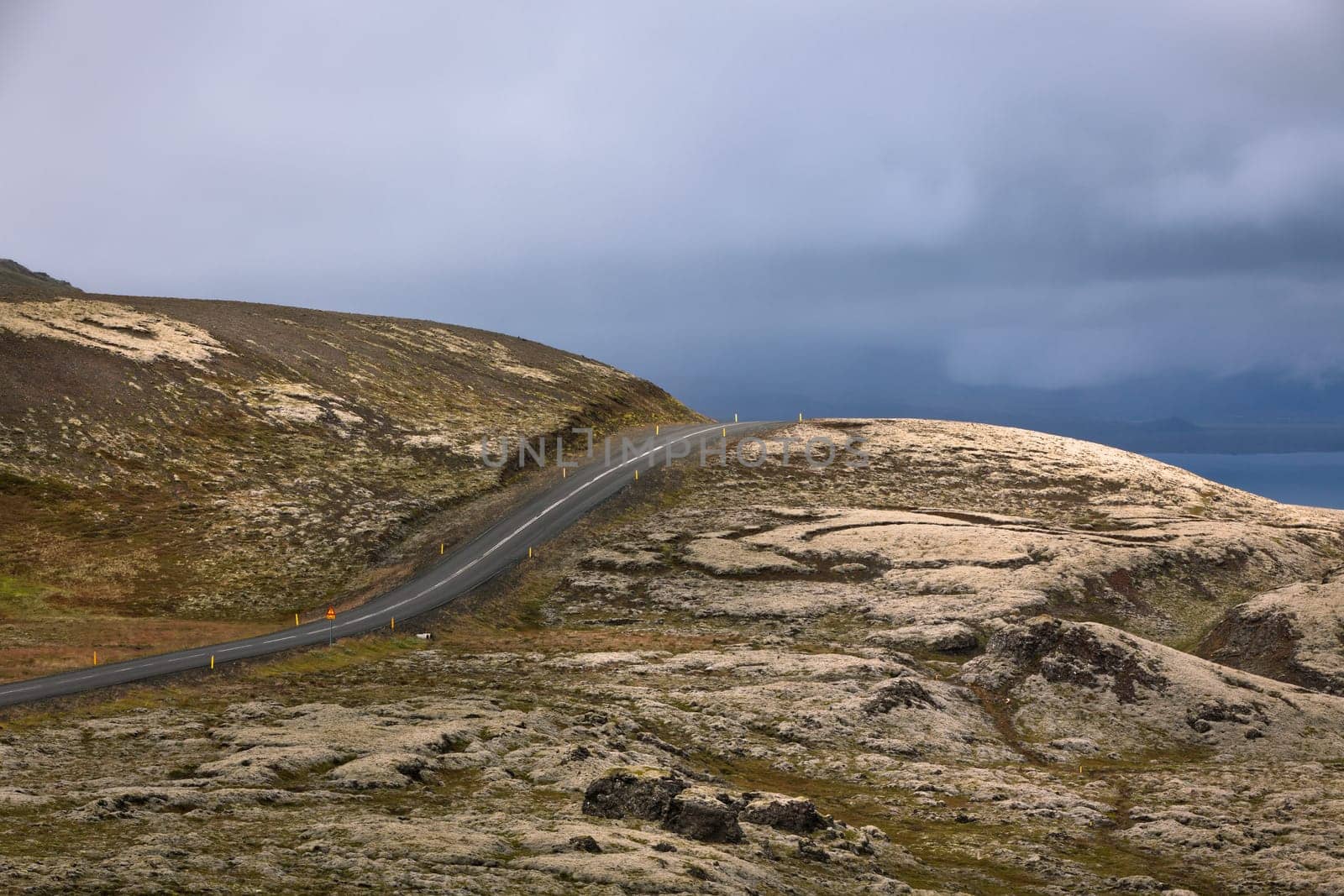 Highway through Iceland landscape at overcast day. Horizontal shot