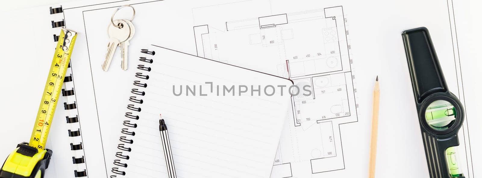 Creative flat lay overhead top view blueprint flat project plan and office supplies on decorator table workspace swatches tools and equipment background copy space concept