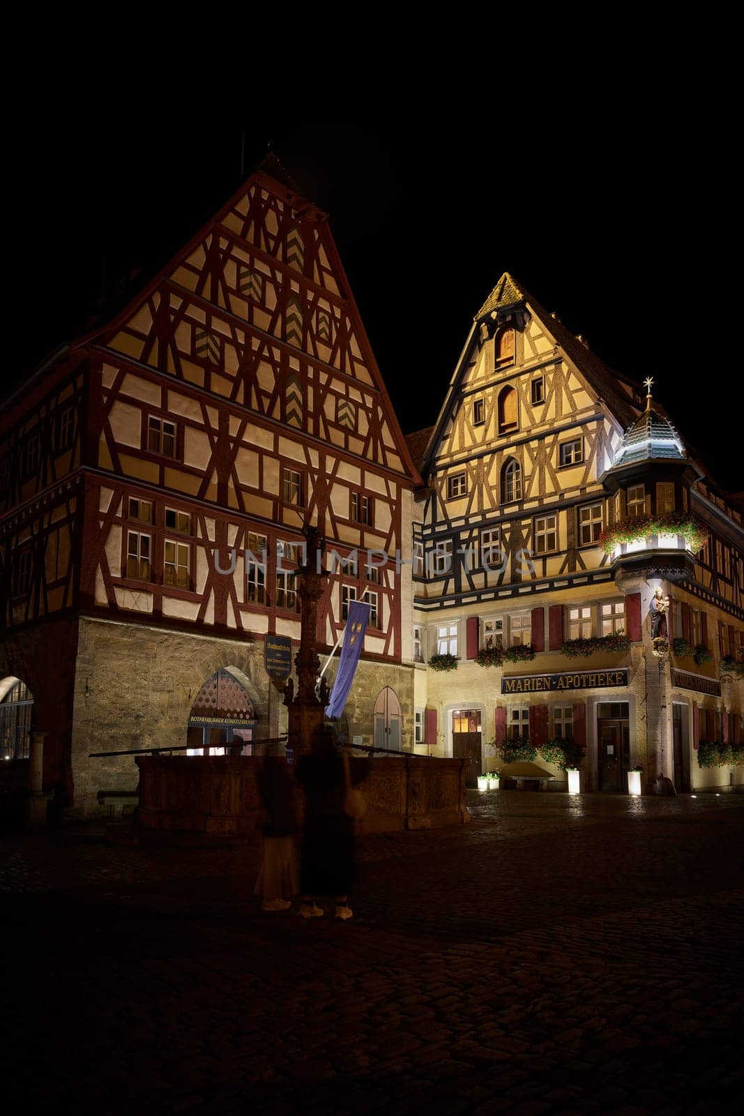 Illuminated historic half-timbered houses in the picturesque old town of Rothenburg ob der Tauber in the Franconia region of Germany