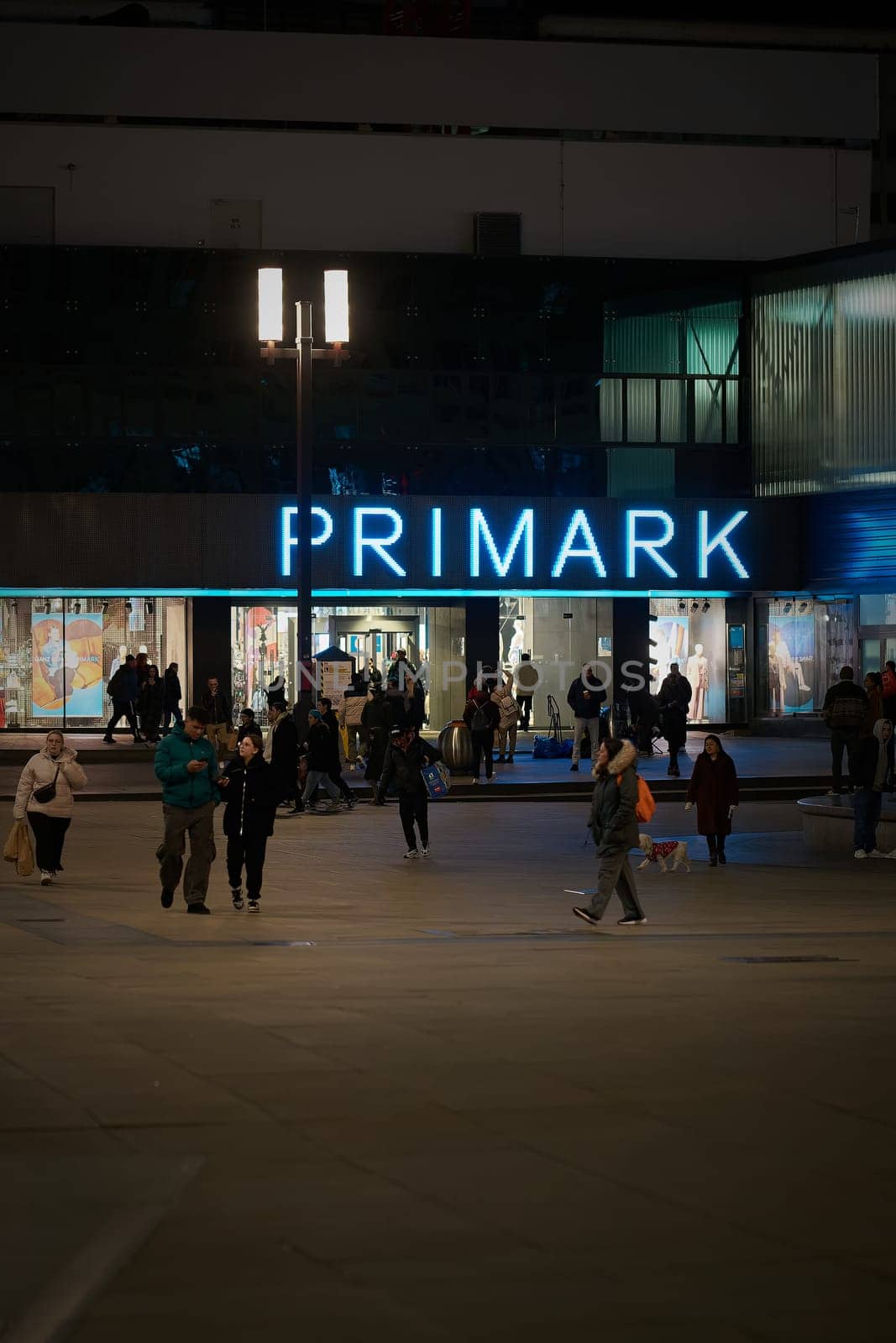 Street scene with some people at Primark on Alexanderplatz in Berlin in Germany in the evening