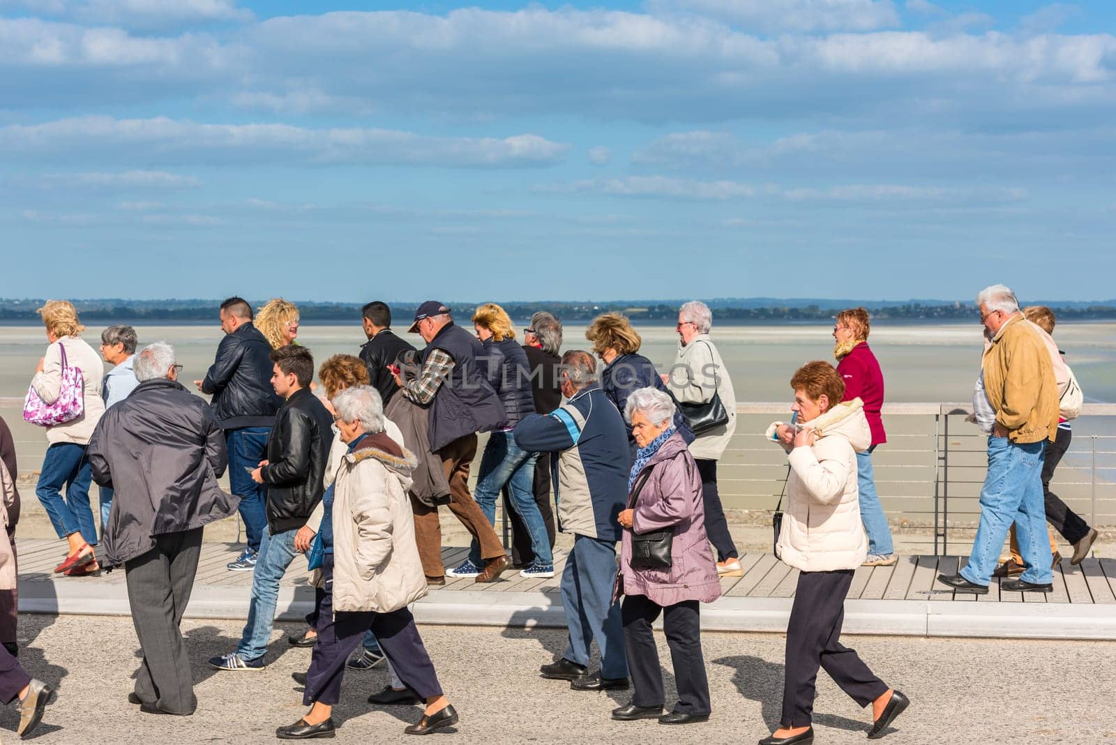 FRANCE, MONT SAINT MICHEL - SEPTEMBER 26: Old people visiting Mont Saint Michel monastery, Brittany, France on September 26, 2015