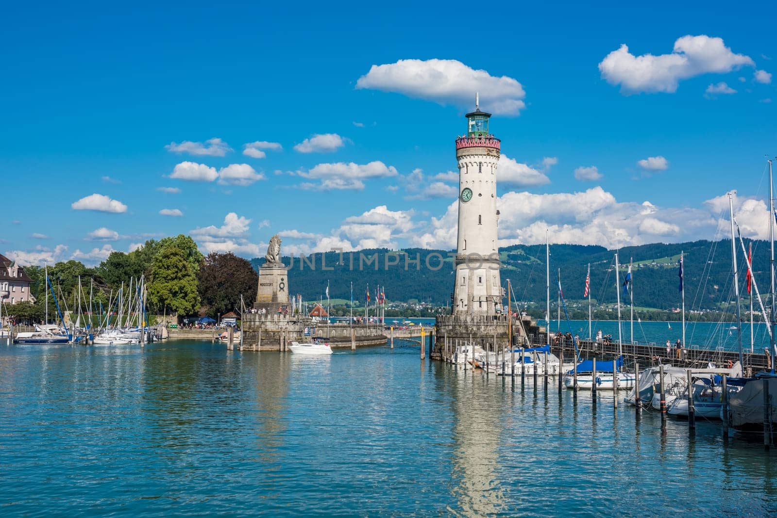 GERMANY, LINDAU - AUGUST 21: view of the lighthouse and a lion statue at the entrance to the port of Lindau at lake Constance, Bodensee on August 21, 2015
