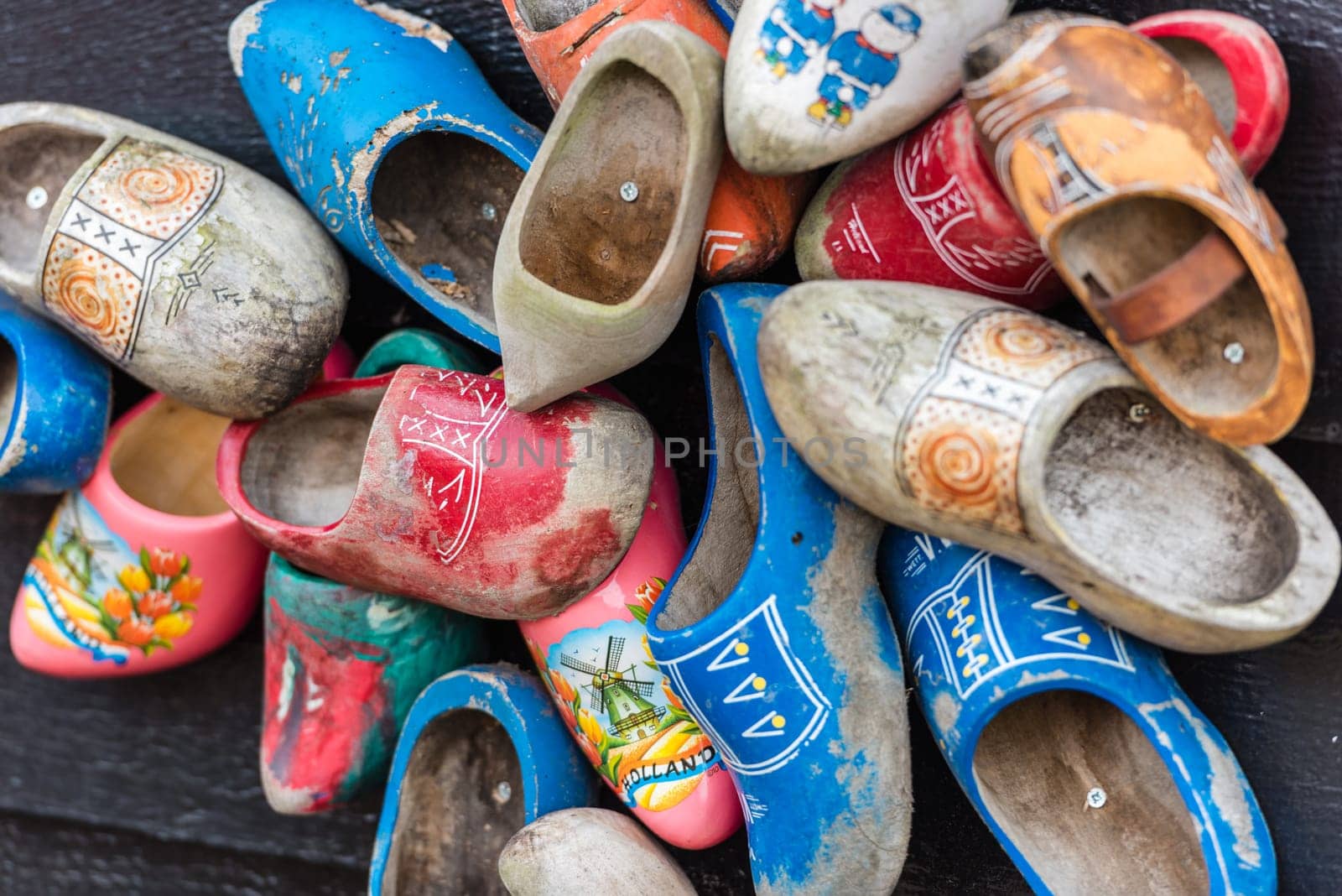 Traditional dutch wooden shoes hanging at a wall. Background