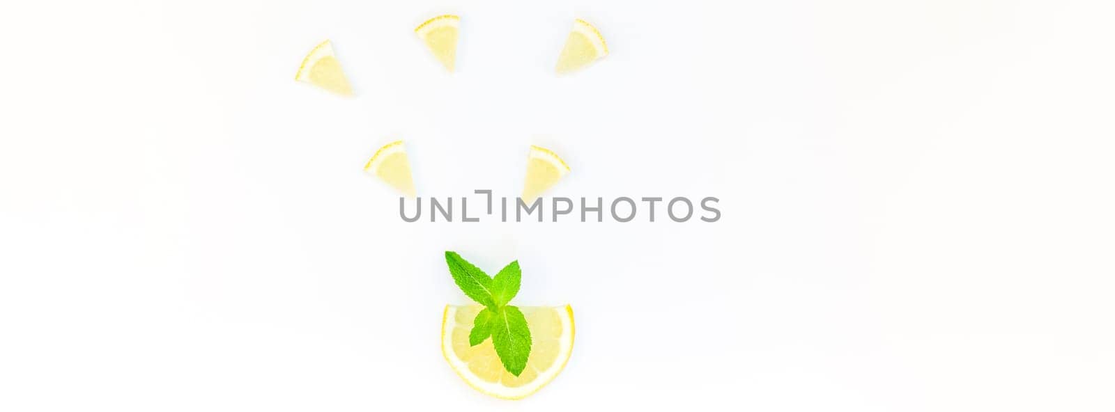 Long wide banner top view citrus lemon slices and mint herbs leaves white table background with copyspace. Hot summer refreshment lemonade concept. Beverage ingredients arranged