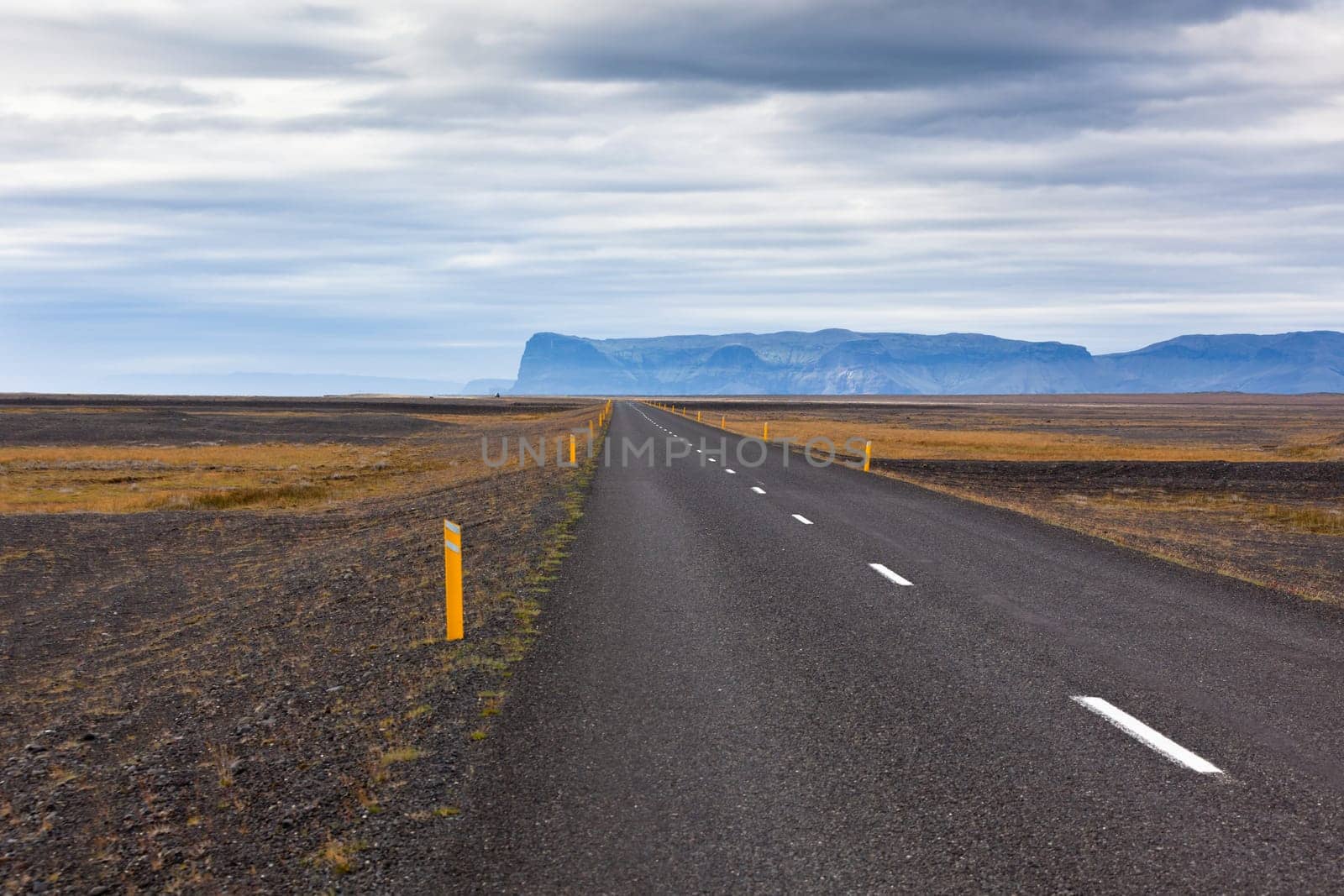 Highway through Iceland landscape at overcast day. Horizontal shot