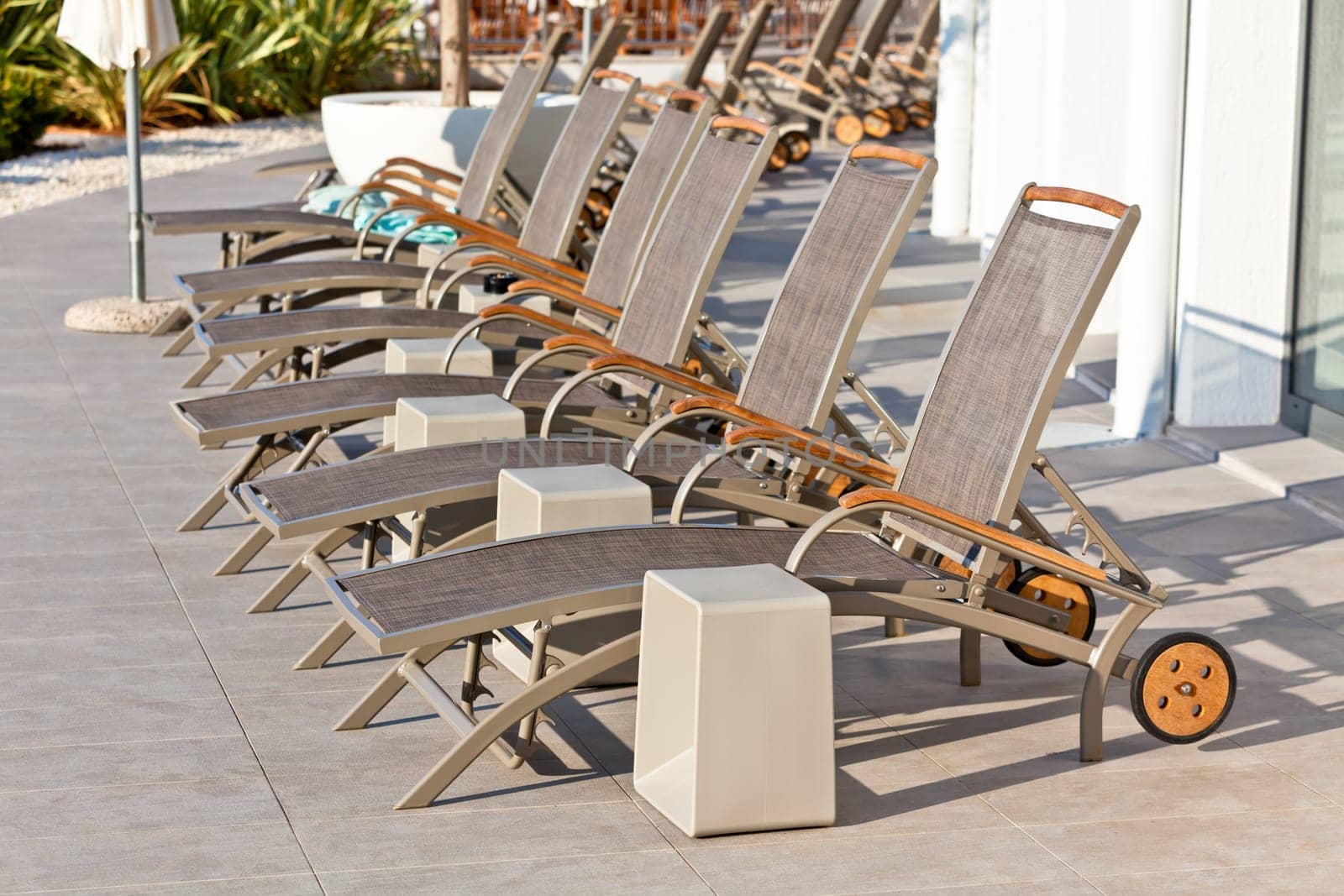 Hotel Wooden Poolside Chairs. Horizontal shot