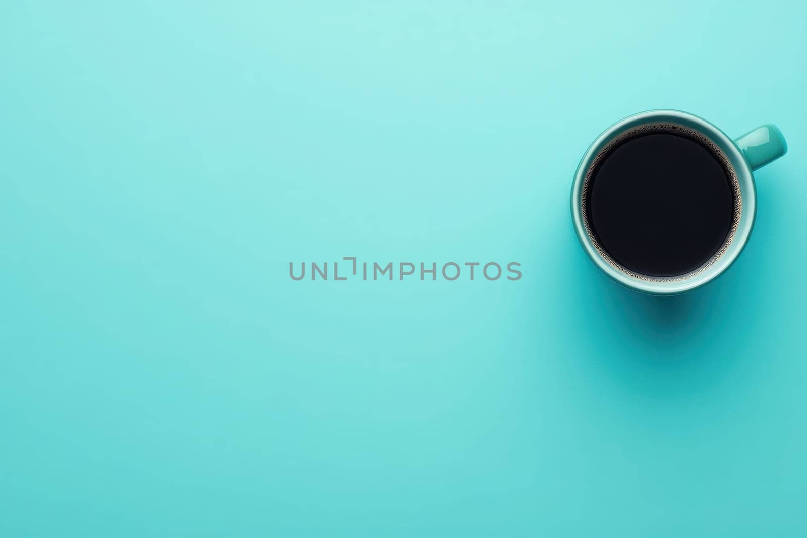 An office desk showcases a clean and minimalistic design featuring a coffee cup filled with dark coffee on a solid turquoise background. This setup invites a focused work atmosphere.