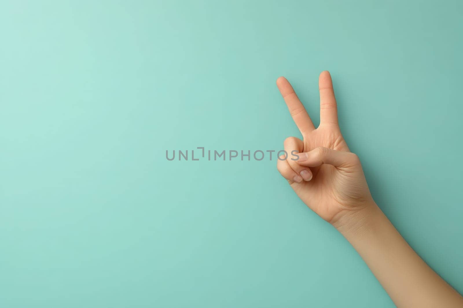 A hand making an okay sign is prominently displayed against a smooth turquoise background, emphasizing positive communication and clarity in a bright environment.