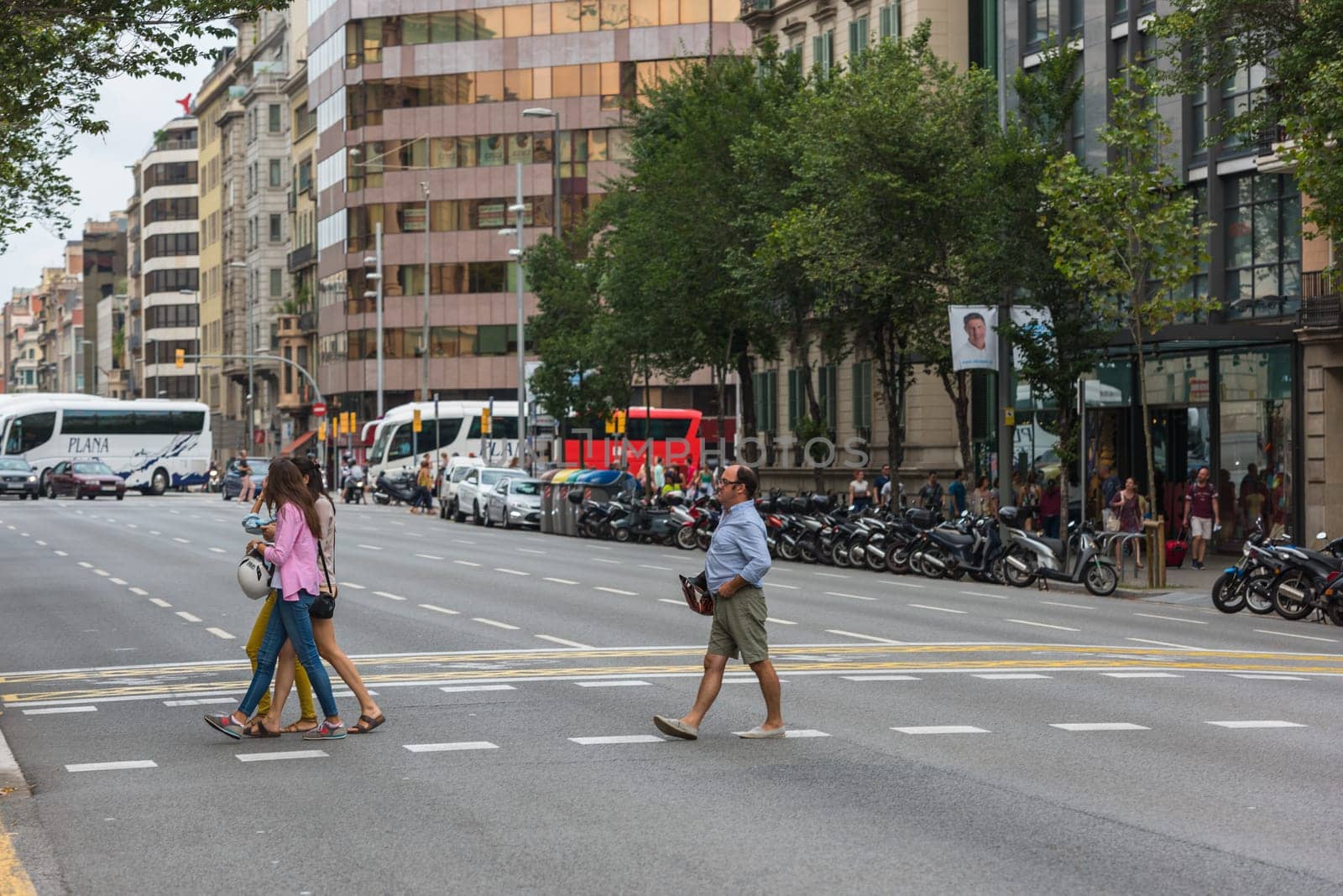 SPAIN, BARCELONA - SEPTEMBER 12: People on a crosswalk, Barcelona street on September 12, 2015