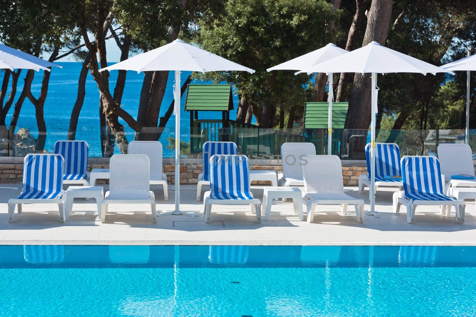 Hotel Poolside Chairs with Sea view. Summer shot