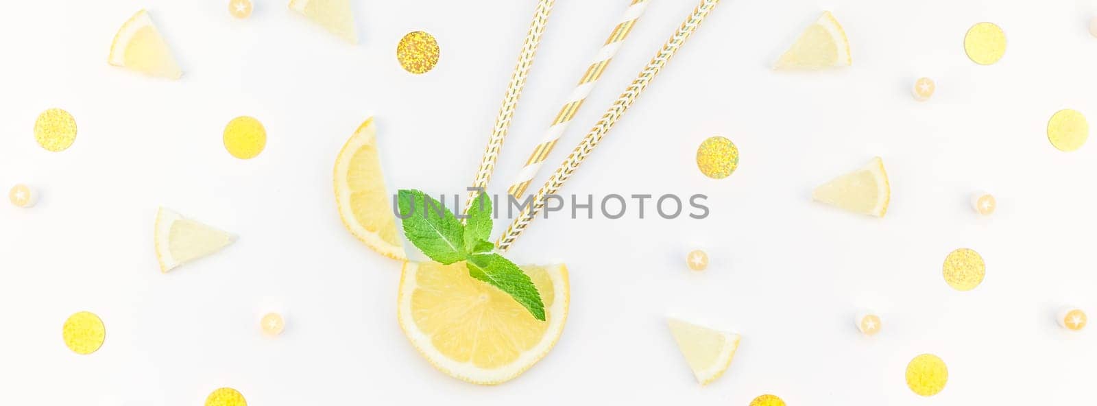 Long wide banner top view citrus lemon slices and mint herbs leaves white table background with copyspace. Hot summer refreshment lemonade concept. Beverage ingredients arranged with straws