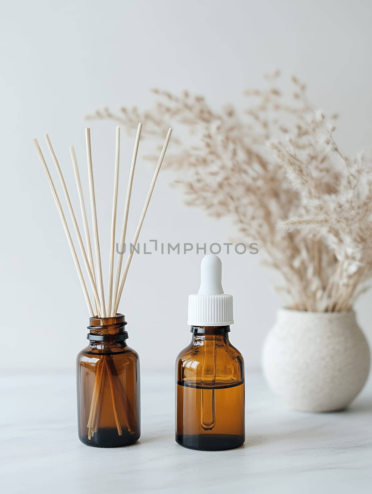 Aromatic oils and diffuser sticks in amber bottles, creating a serene and fragrant atmosphere.