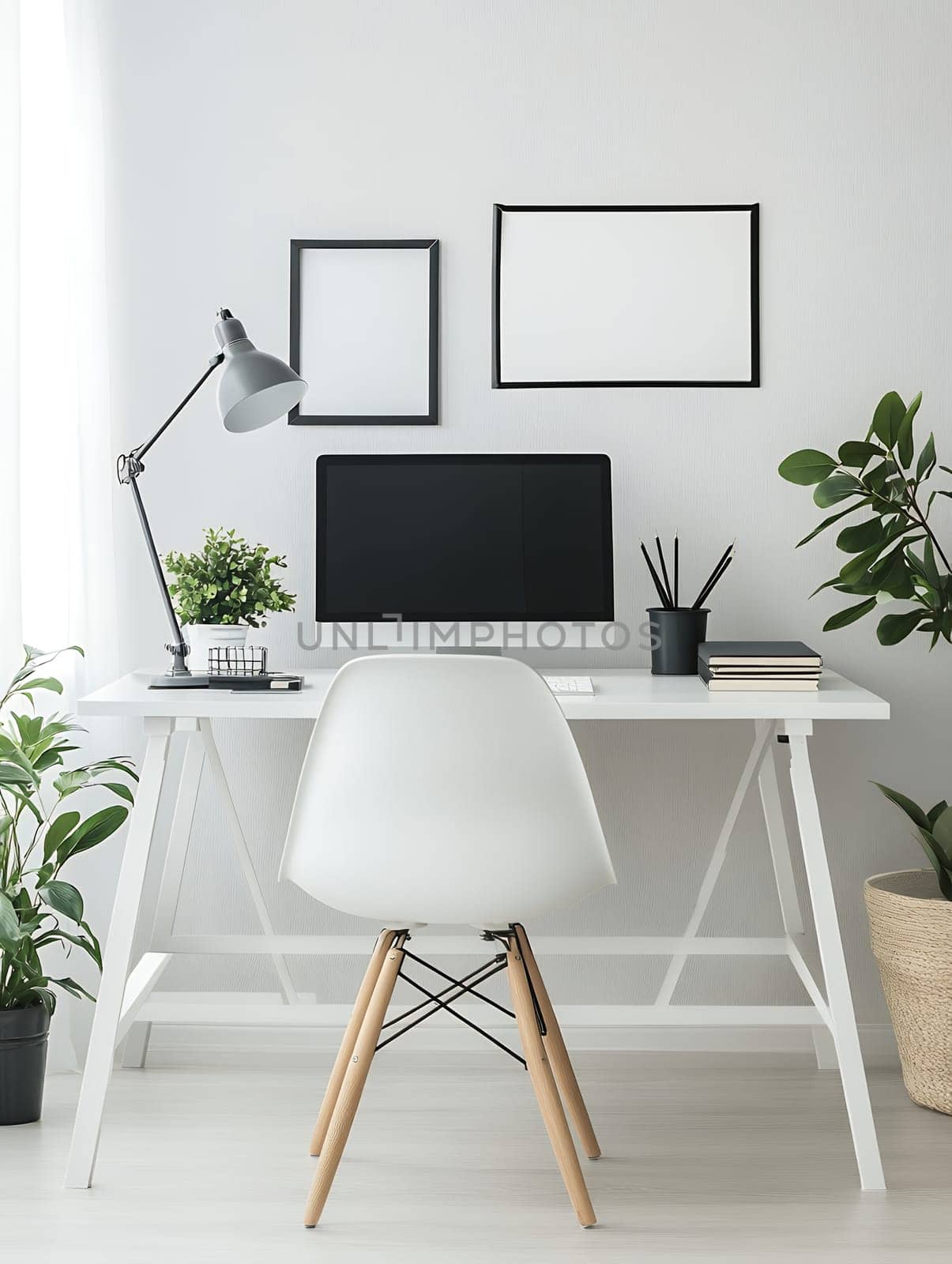 Minimalist home office interior with white desk, computer, chair and empty frames on wall, stylish workspace with plants and copy space.