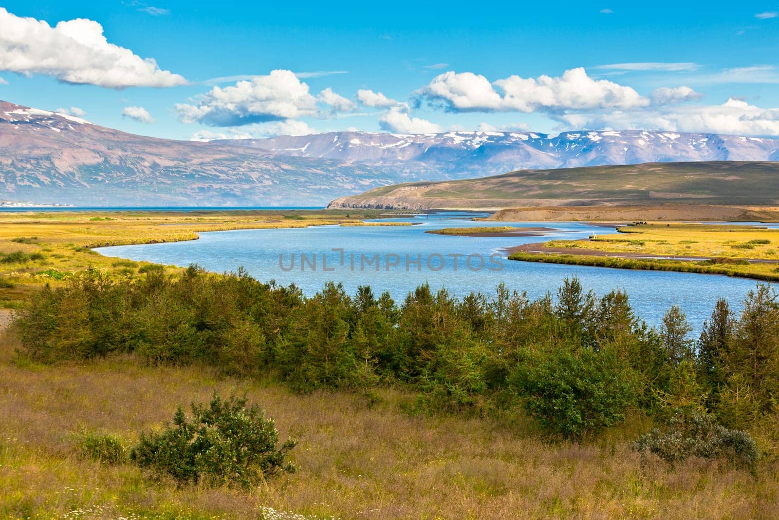 Summer Iceland Landscape with River, Mountains and Bright Blue Sky