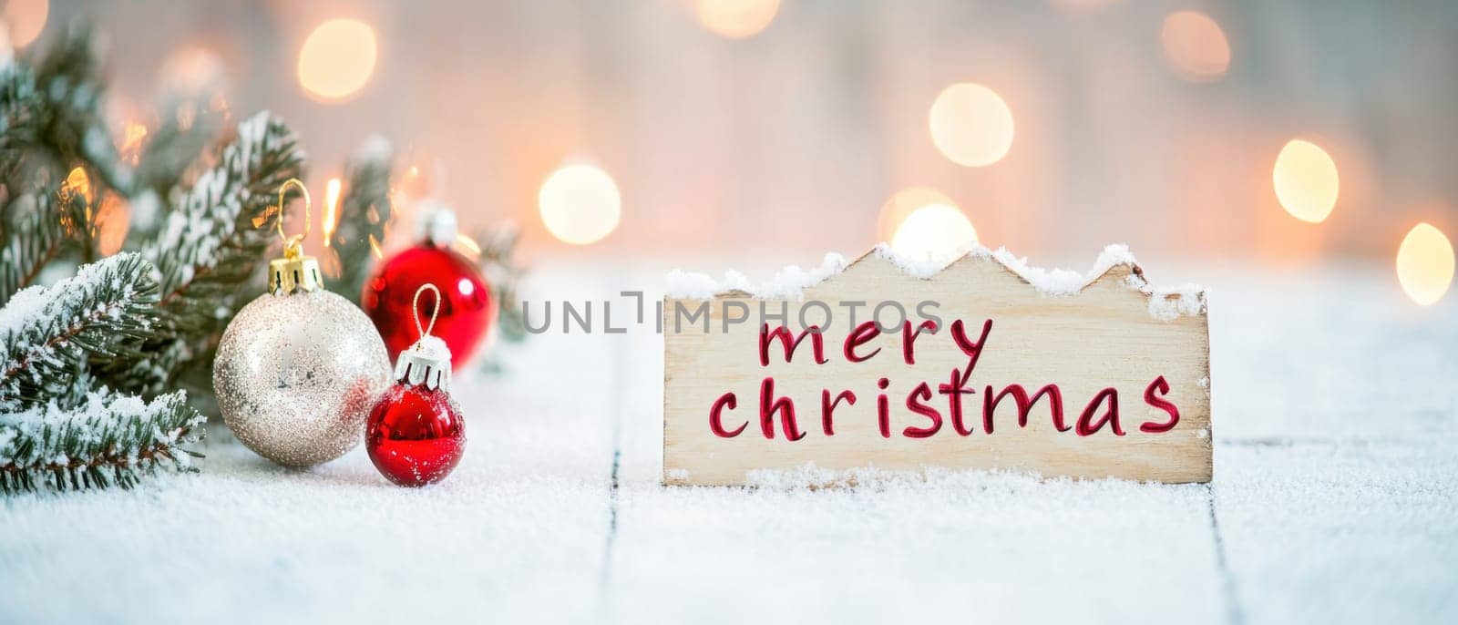 A cozy winter setting displays a Merry Christmas sign alongside ornaments and pine branches creating a warm holiday atmosphere.