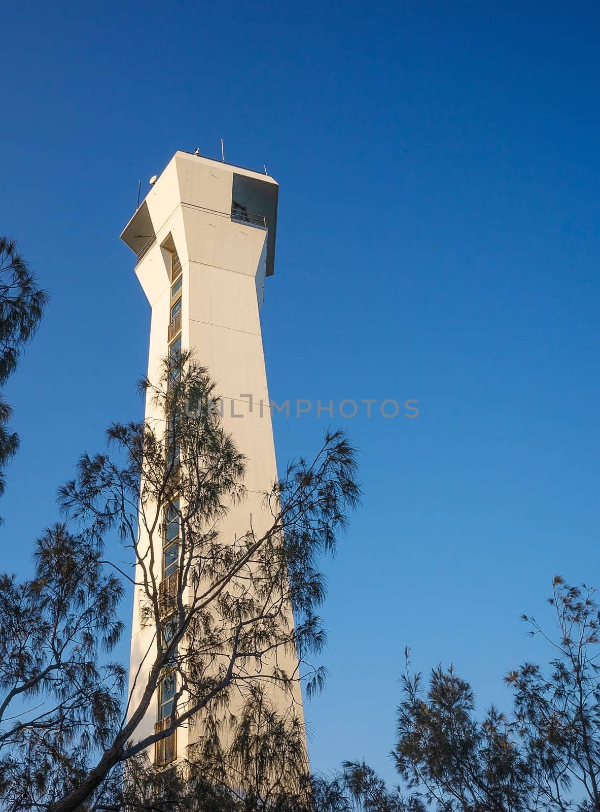 Close up of Point Cartwright lighthouse, navigational beacon, in soft, late afternoon light