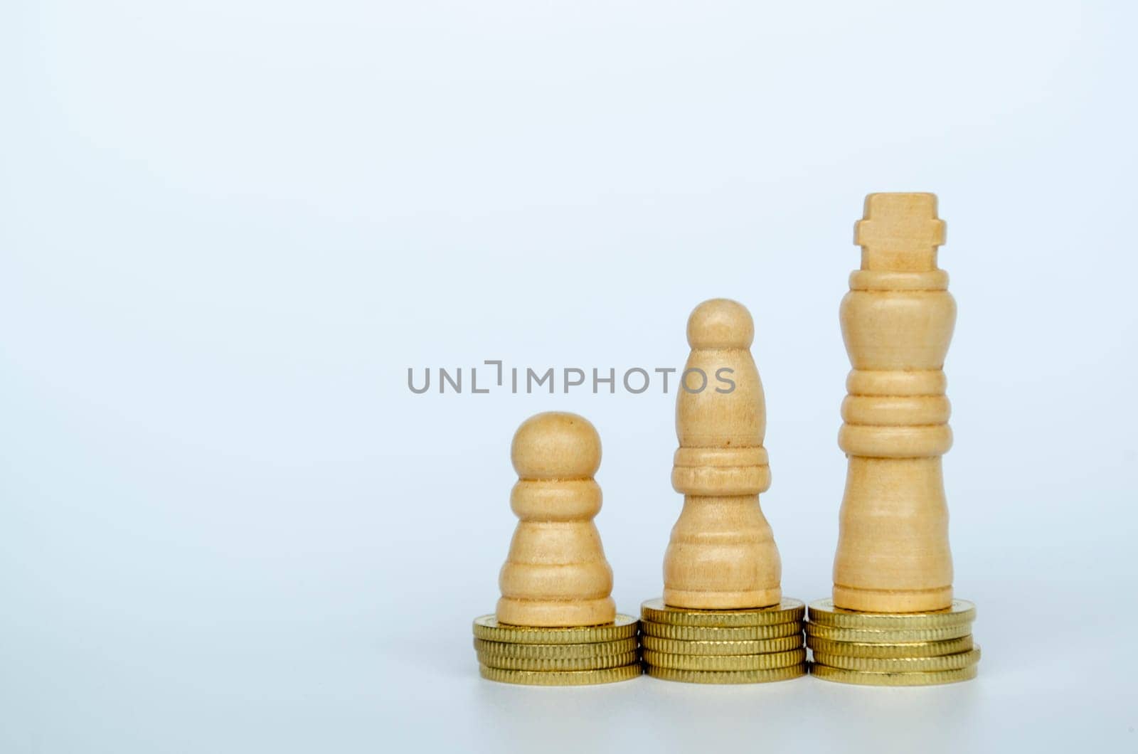 Chess pawns on top of golden stacking coins with customizable space for text.