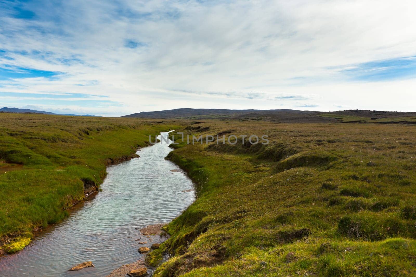 Summer Iceland Landscape with River, Green Fields and Bright Blue Sky