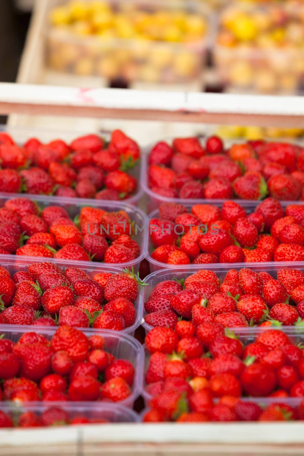 Natural organic strawberries in boxes at a farmers market