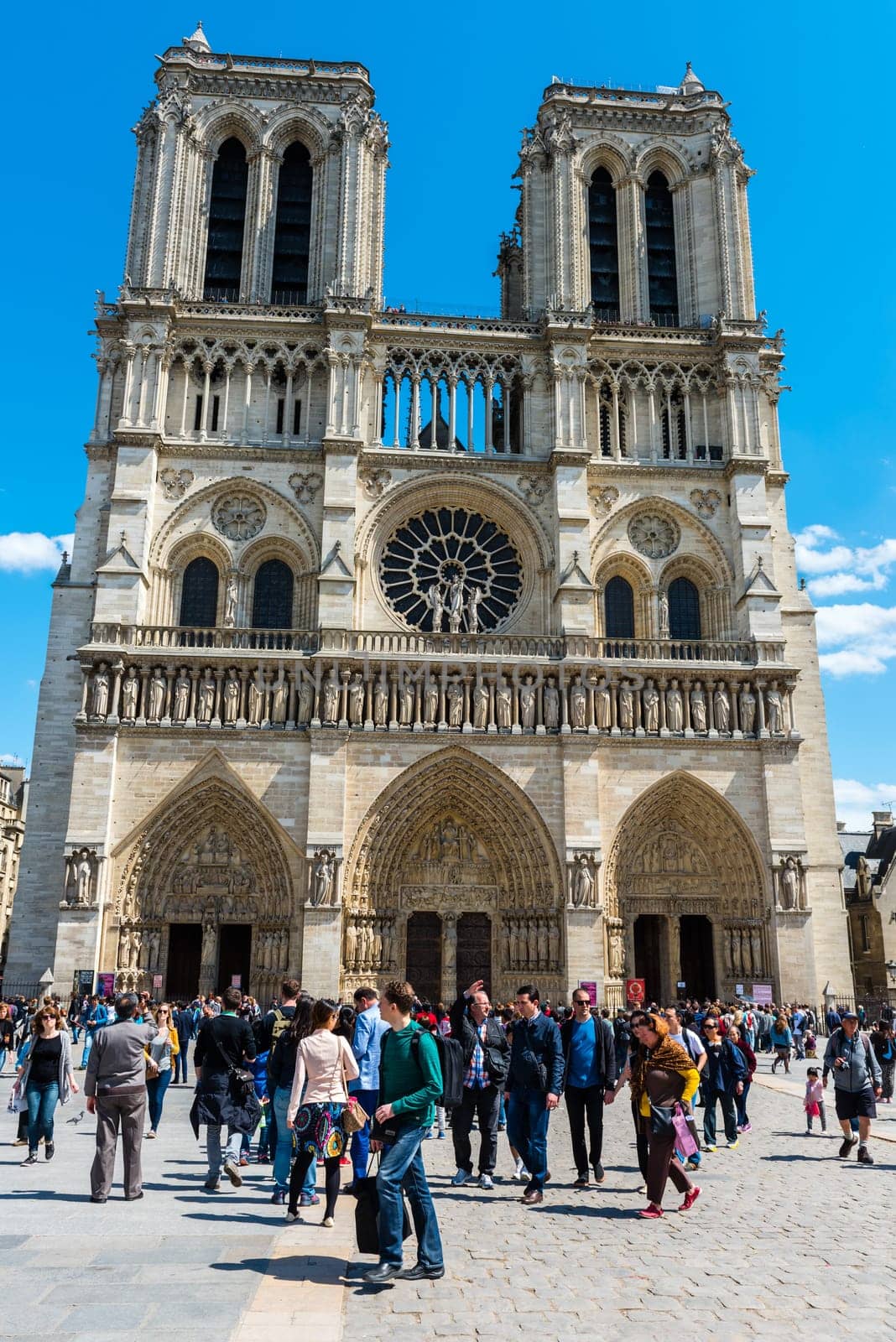 FRANCE, PARIS - JUNE 01: People on the street before the Notre Dame Cathedral in central Paris on June 01, 2015