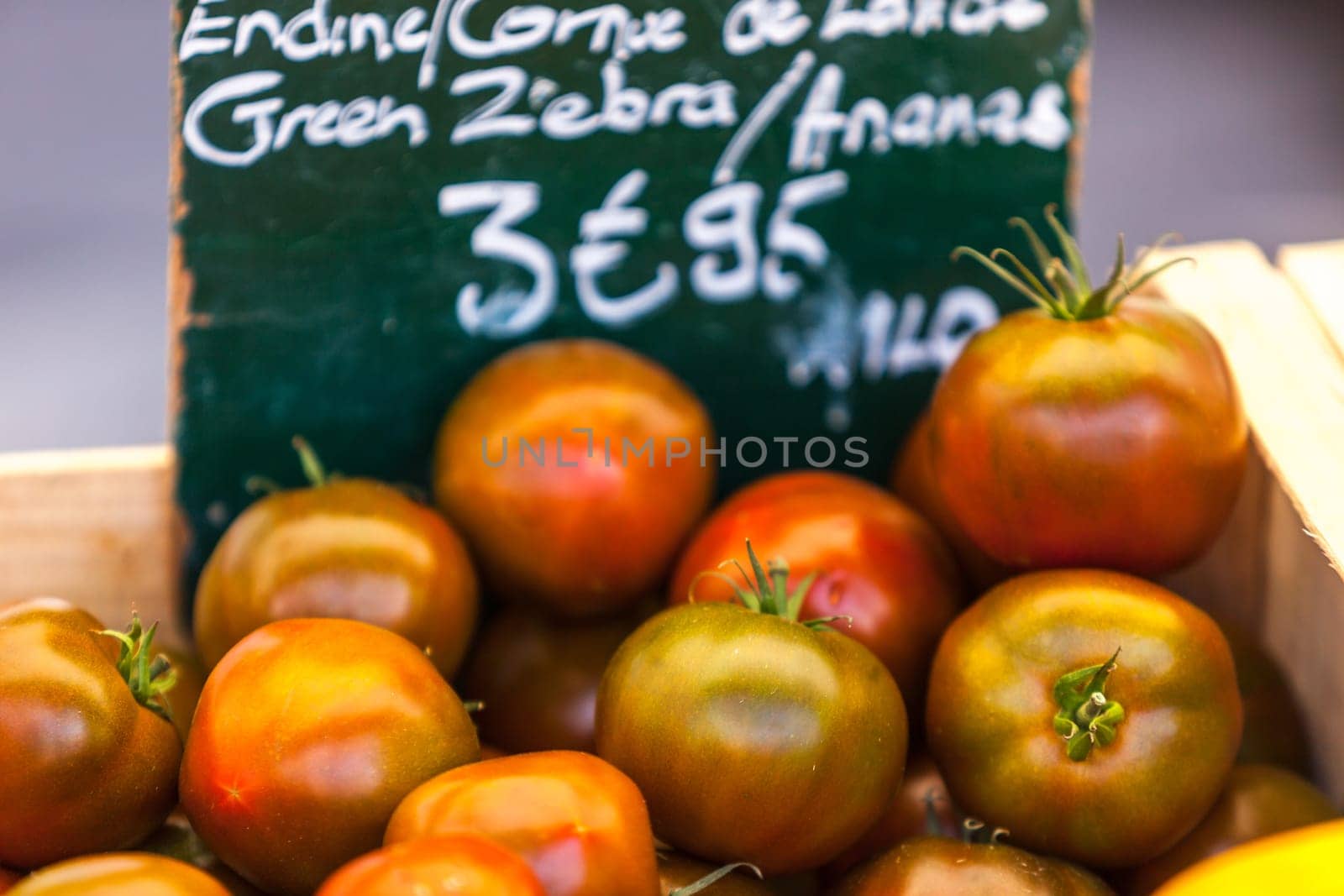 FRANCE, LYON - AUGUST 07: Natural organic tomatoes in boxes on farmer's market on August 07, 2014