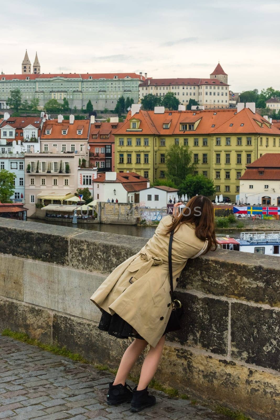 THE CZECH REPUBLIC, PRAGUE - MAY 19: Woman is taking pictures on the Charles bridge in Prague, Czech on May 19, 2015