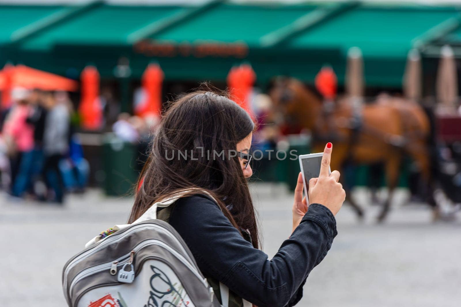 BELGIUM, BRUGES - MAY 22: Woman is taking pictures on the street of Bruges on May 22, 2015