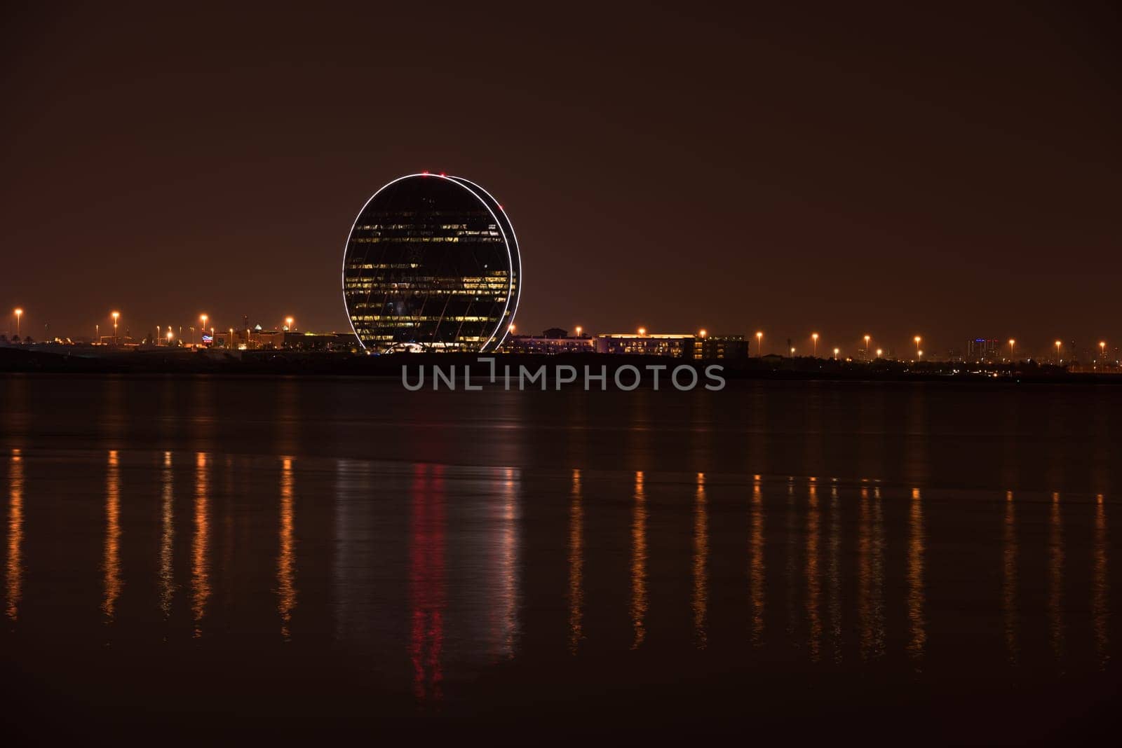UAE, ABU DHABI - DECEMBER 20: View of Aldar headquarters building and night skyline of Abu Dhabi, UAE on December 20, 2014