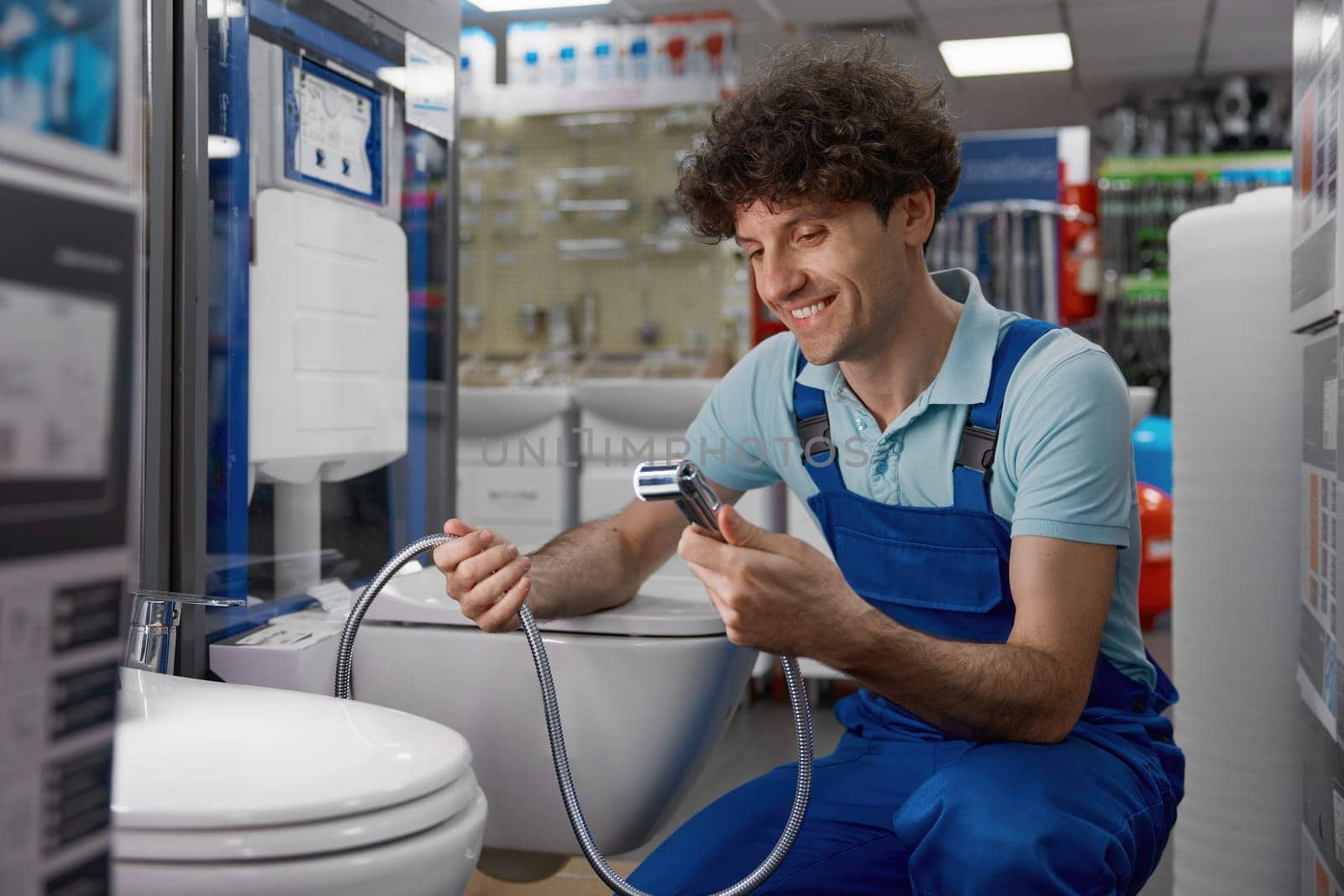 Plumber examining modern range of luxury bidets with in smart toilet technology. Best offer at plumbing store