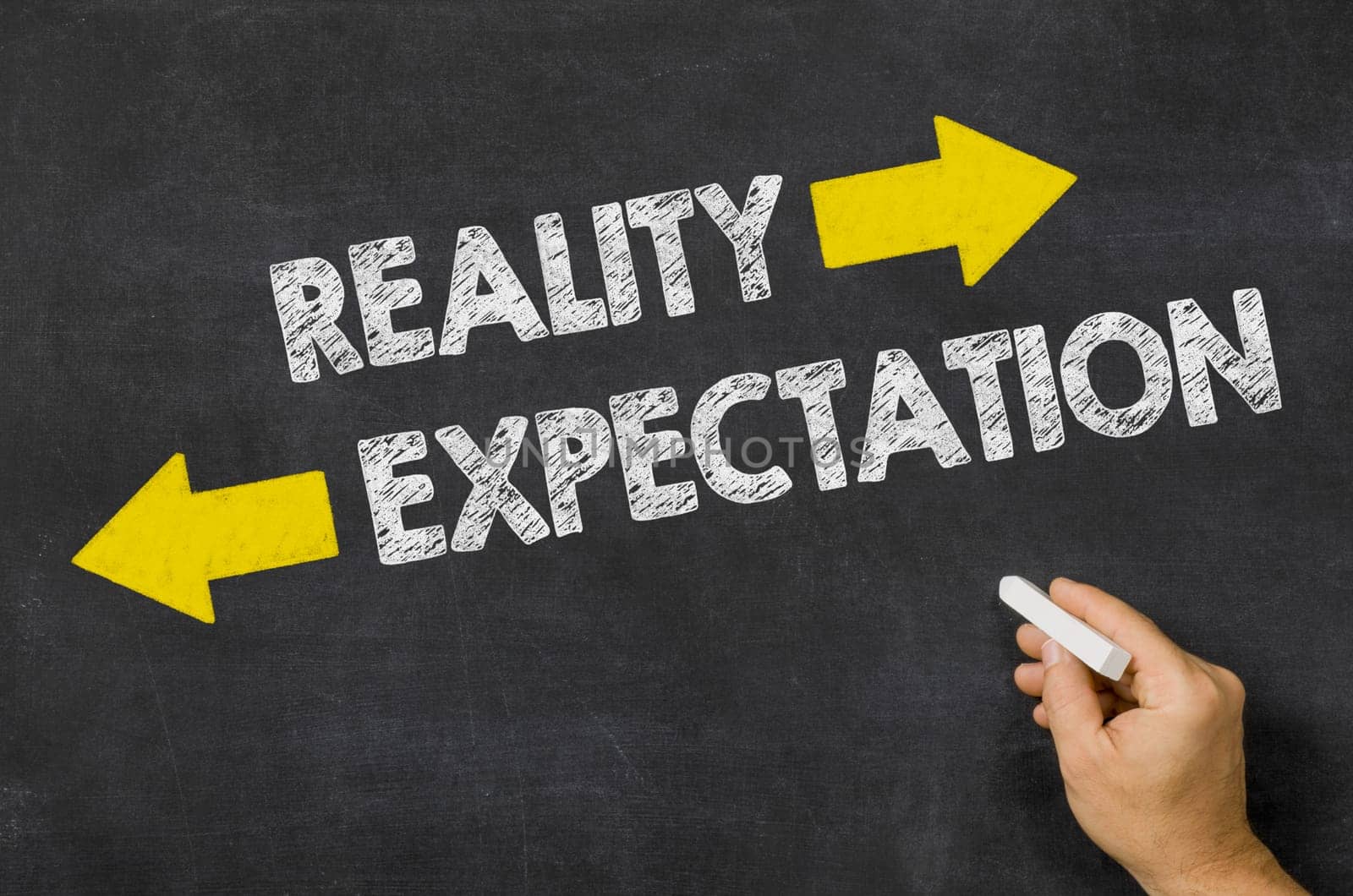 Reality or Expectation written on a blackboard