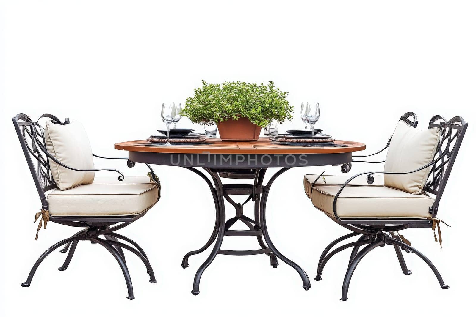 A beautifully arranged outdoor dining set features a round table with a rich wood top, comfortable cushioned chairs, and a potted plant centerpiece, ideal for al fresco meals in a garden setting.
