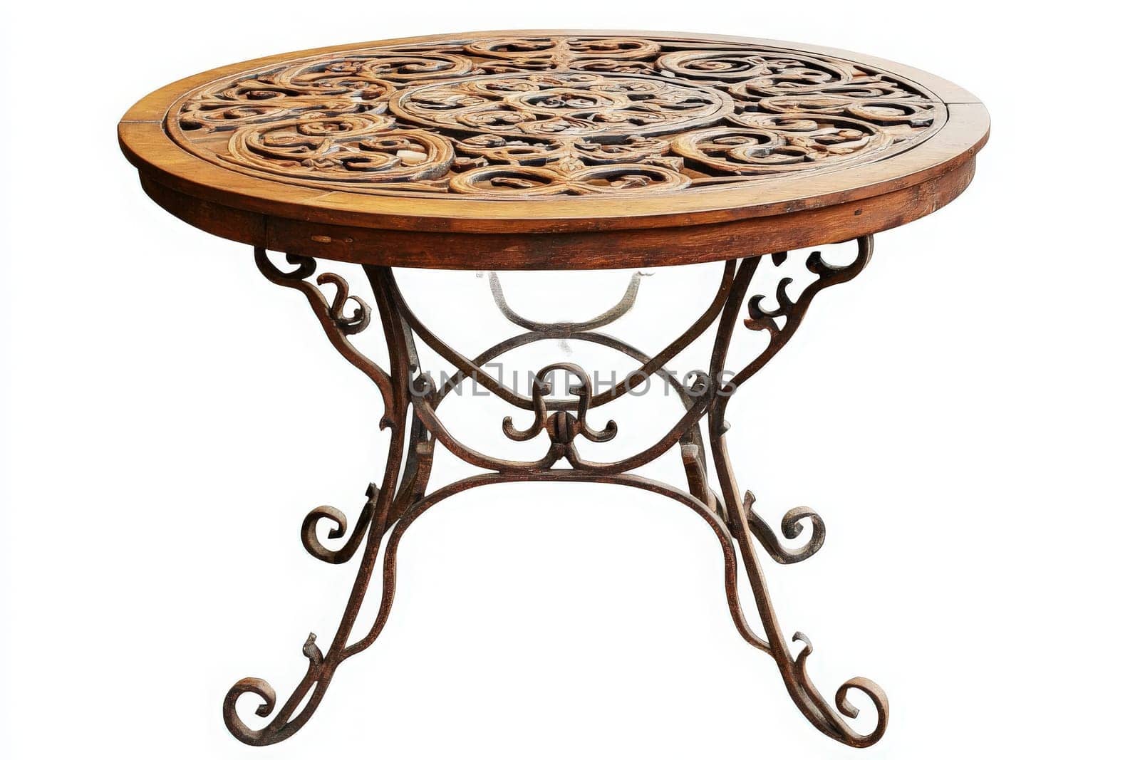 A decorative wrought iron patio table stands isolated, showcasing intricate designs in its tabletop. Ideal for outdoor gatherings, it exudes charm and functionality in serene surroundings.