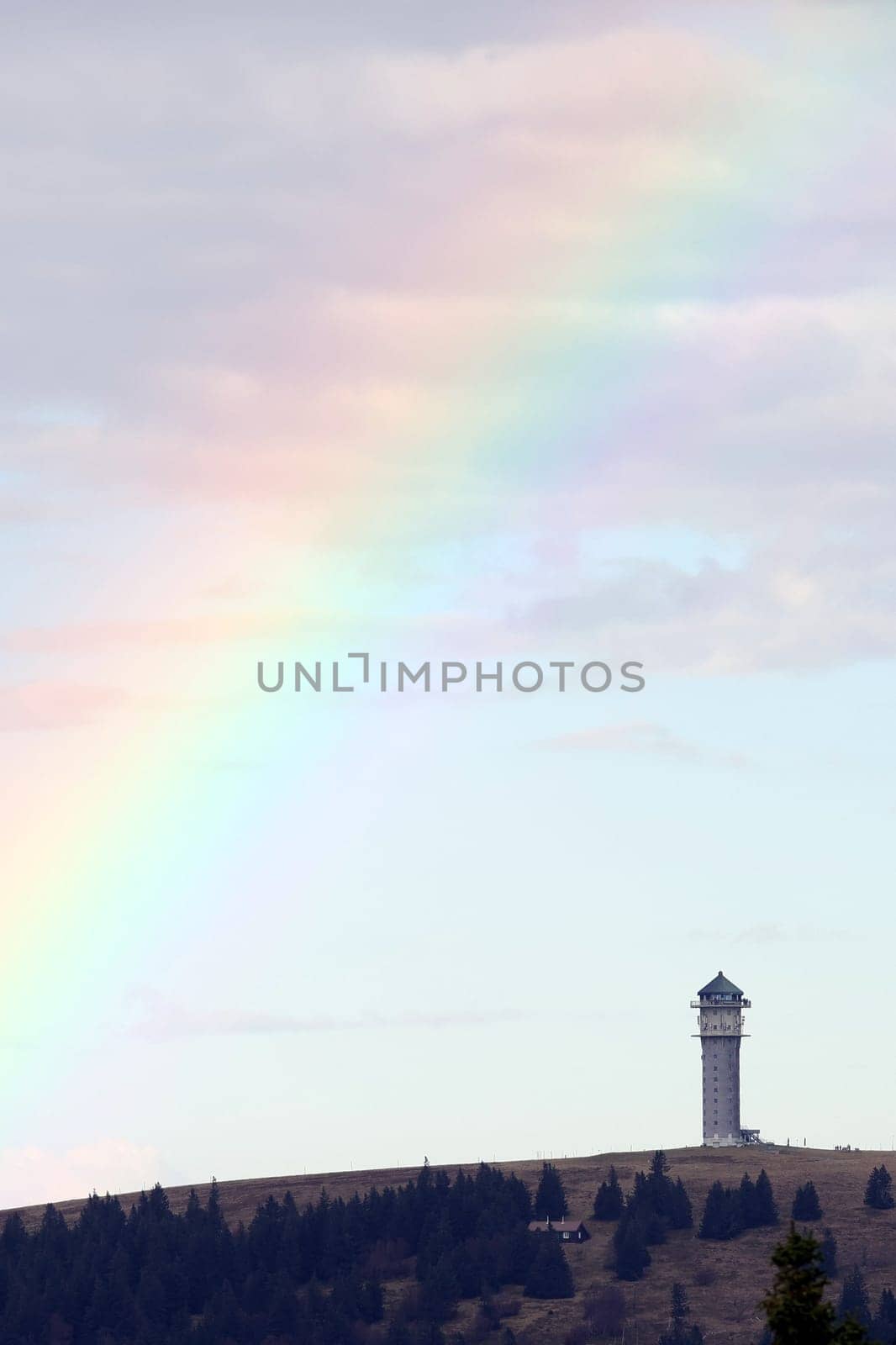 Colourful natural spectacle: After a short rain shower and the sun coming through again,the highest elevation in Baden-Württemberg,the Feldberg Tower,presented itself with a rainbow tail