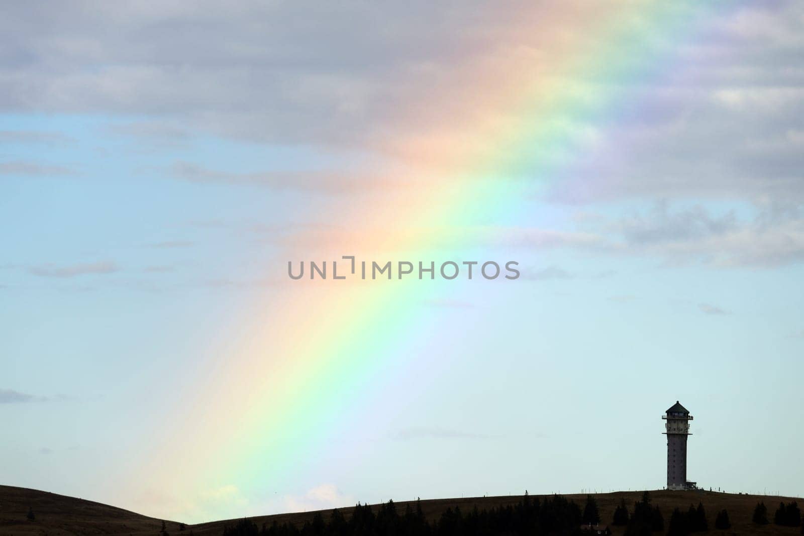 Colourful natural spectacle: After a short rain shower and the sun coming through again,the highest elevation in Baden-Württemberg,the Feldberg Tower,presented itself with a rainbow