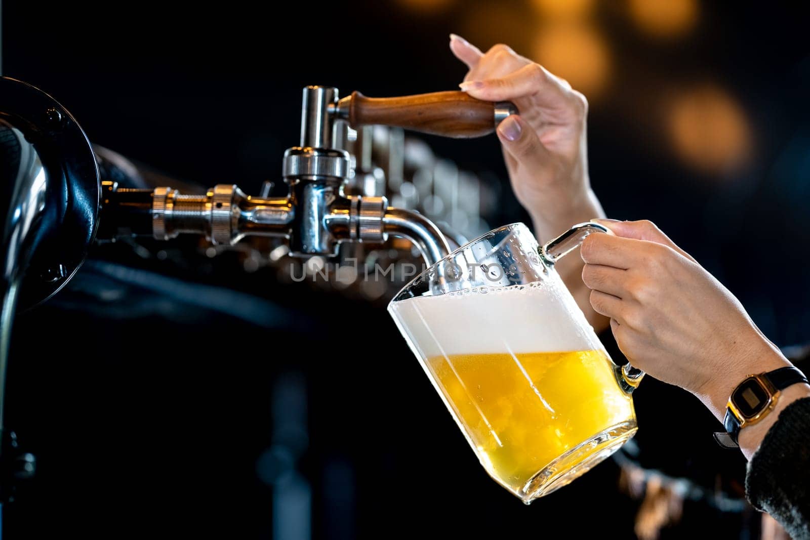Skilled bartender pouring cold beer in lively pub setting, creating refreshing drink with perfect foam layer. Nightlife joy captured in bustling bar atmosphere