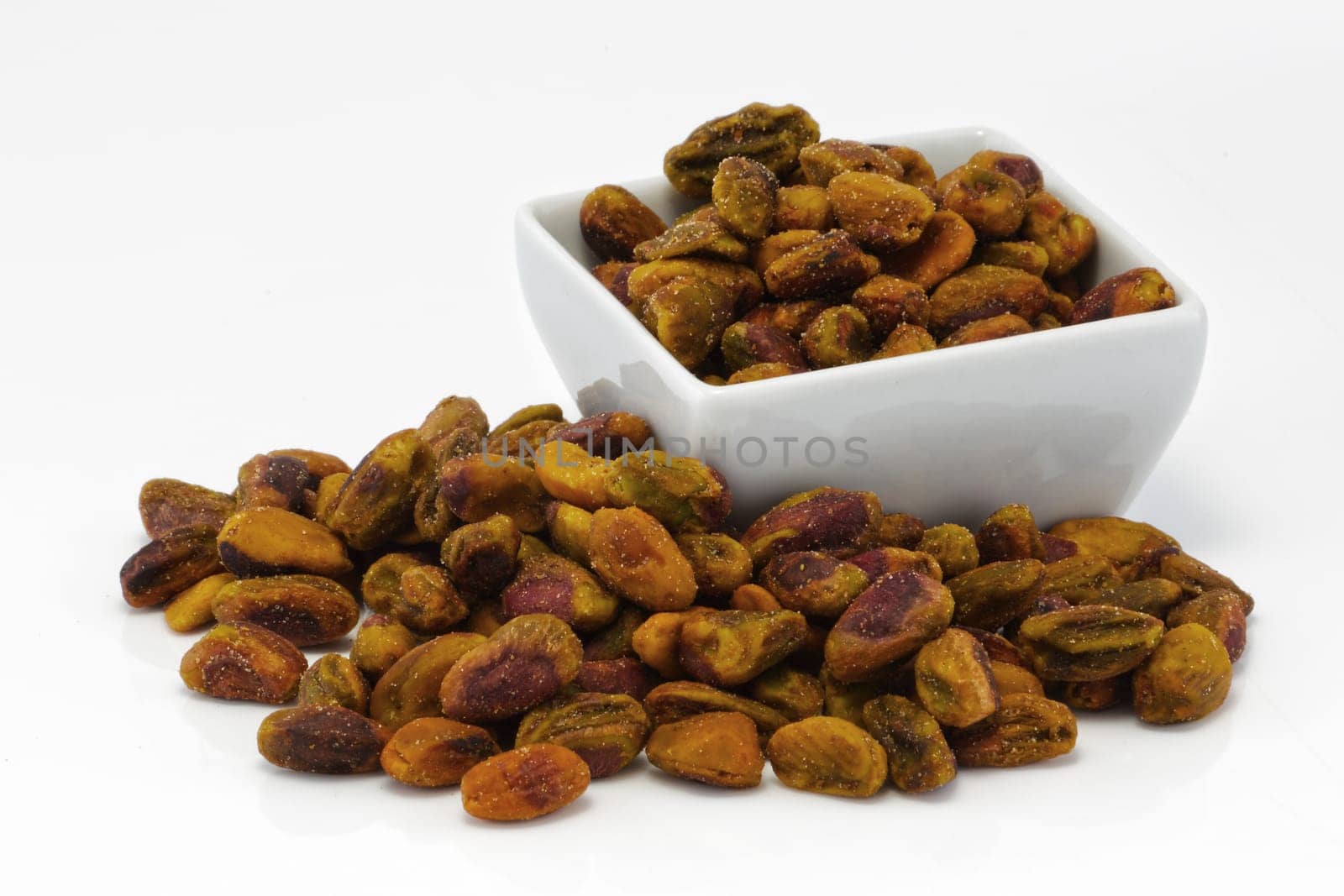 Pistachio nuts in a group on white