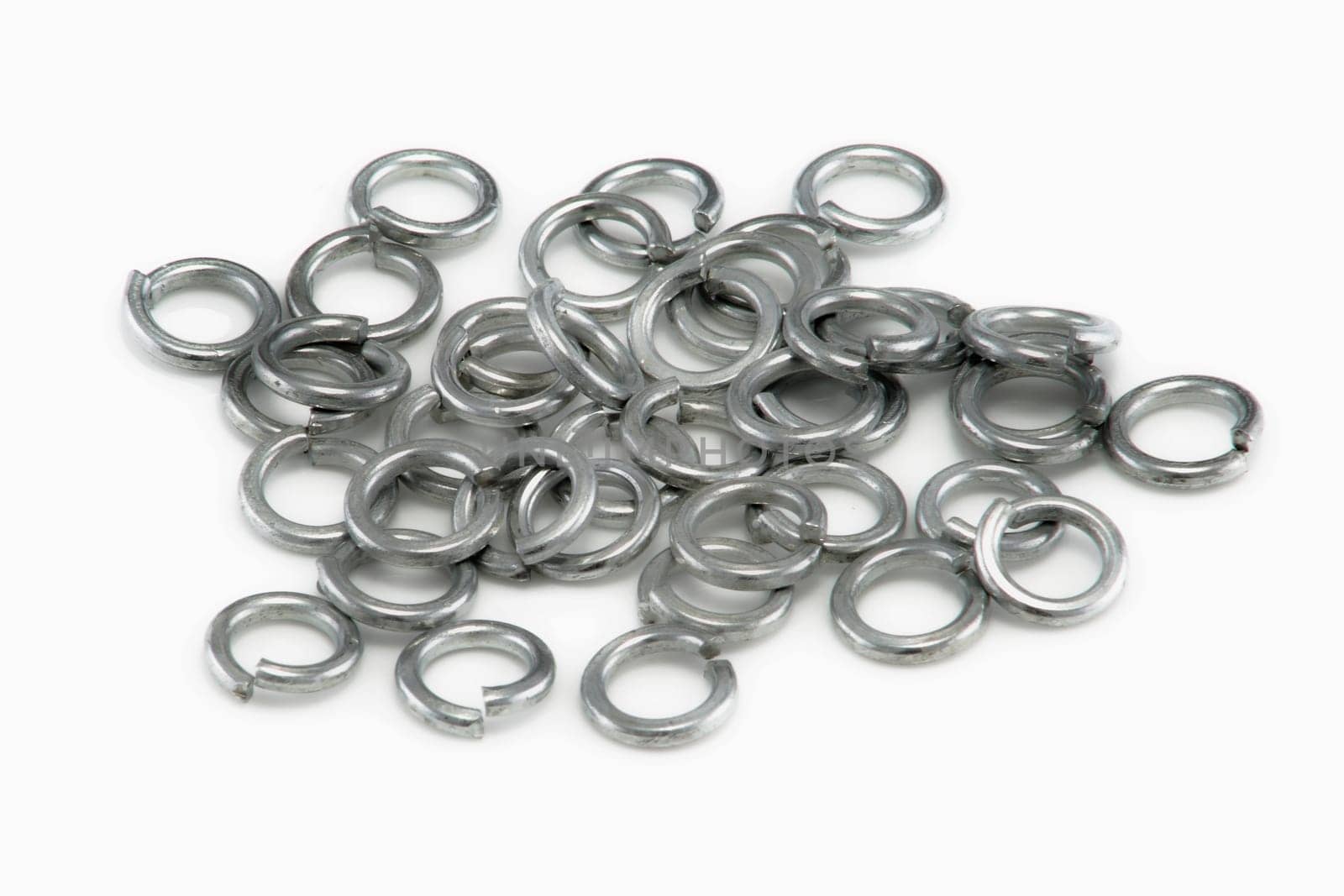 A Pile of chrome split spring washers on white background