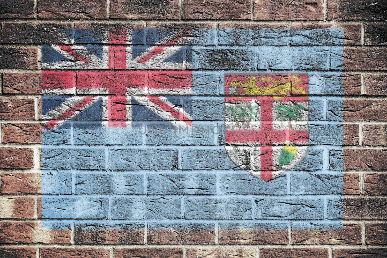 A Fiji flag on brick wall background union jack coat of arms