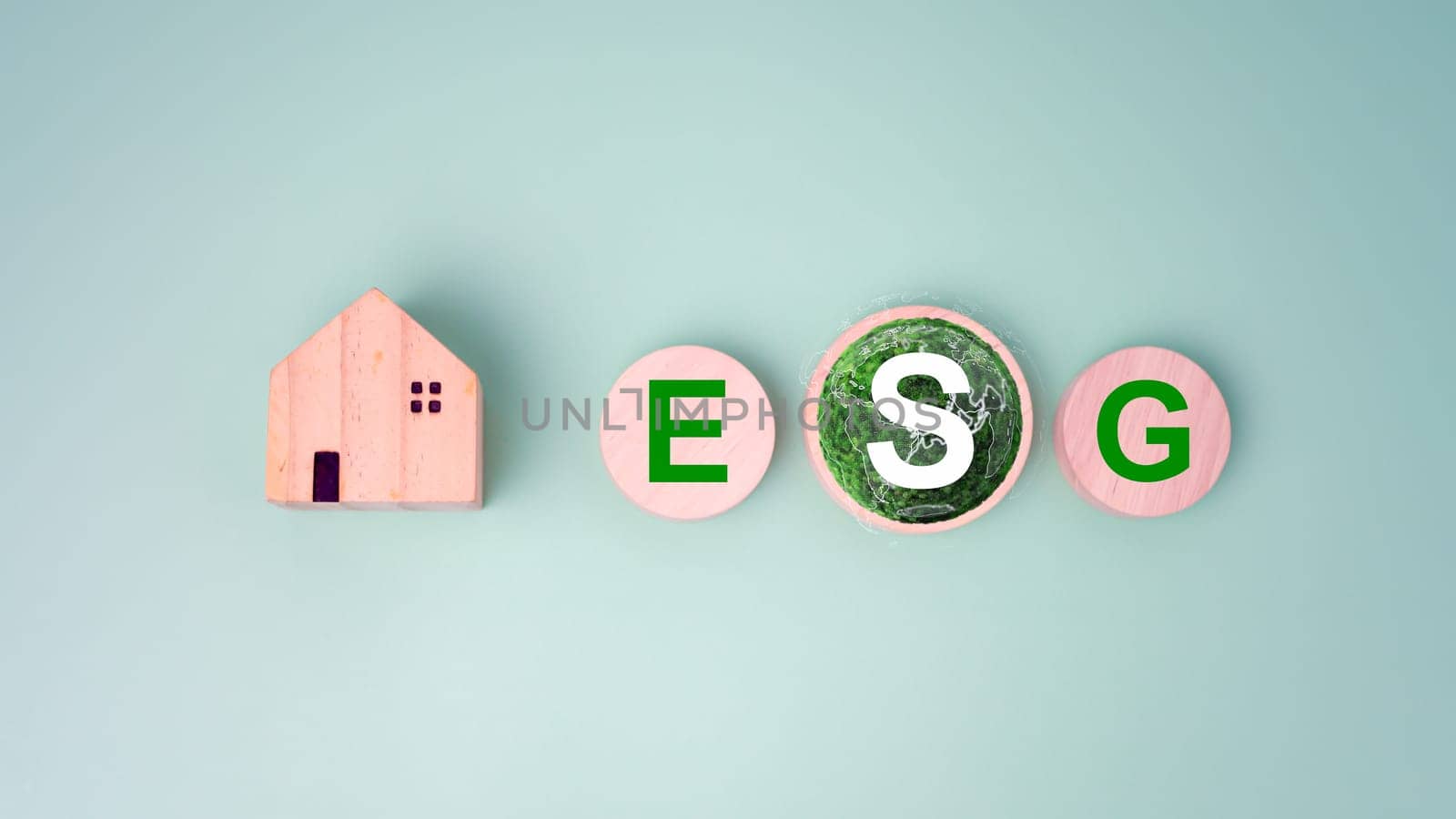 Wooden home and circular wooden board with the abbreviation ESG printed on a light green background, ESG concepts for sustainable environment, Society and governance is environmentally responsible.