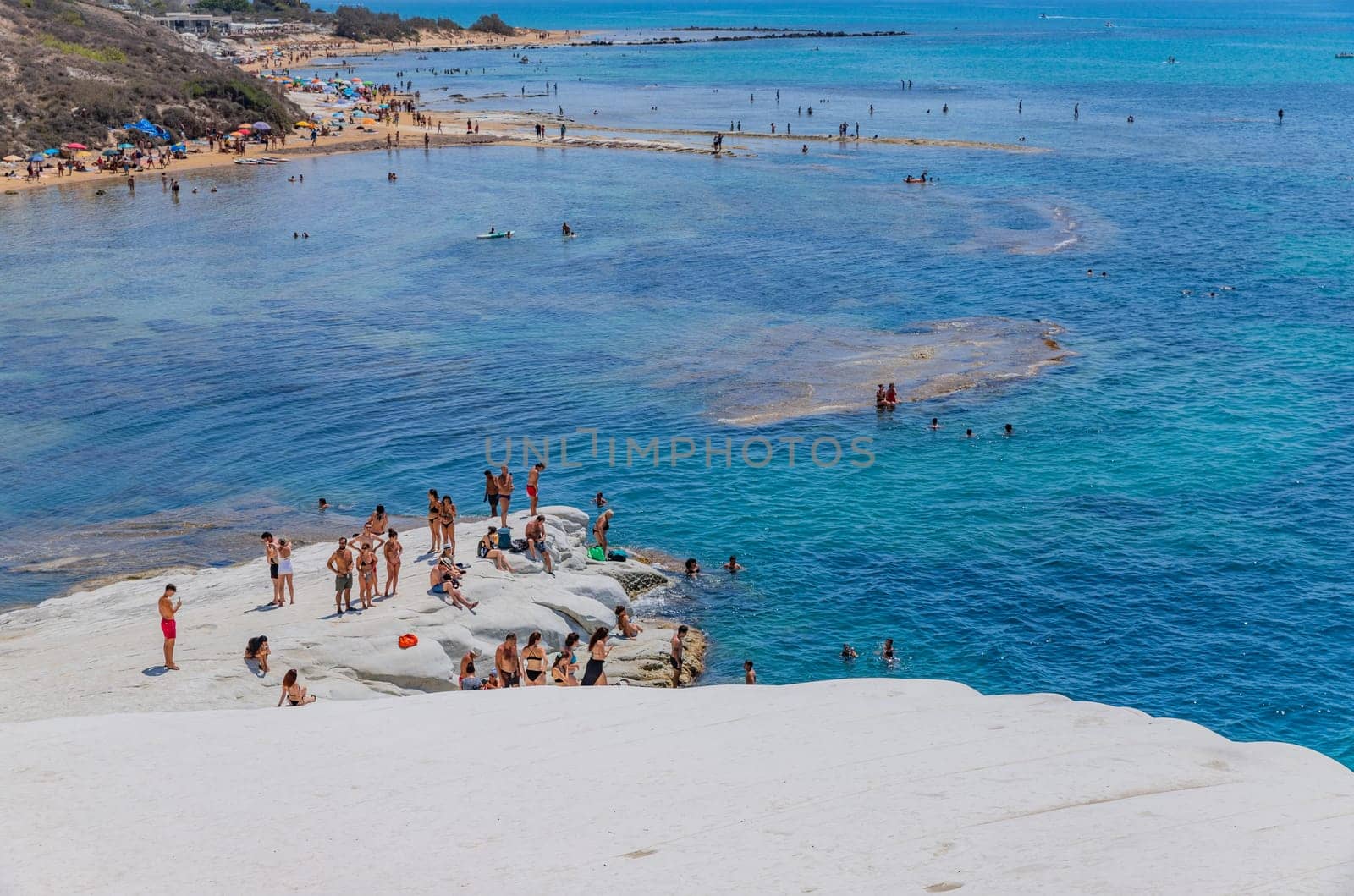 Sicily, Italy: August 9, 2024: Some people at the Beach of Scala dei Turchi (Stair of the Turks) in Sicily, Italy