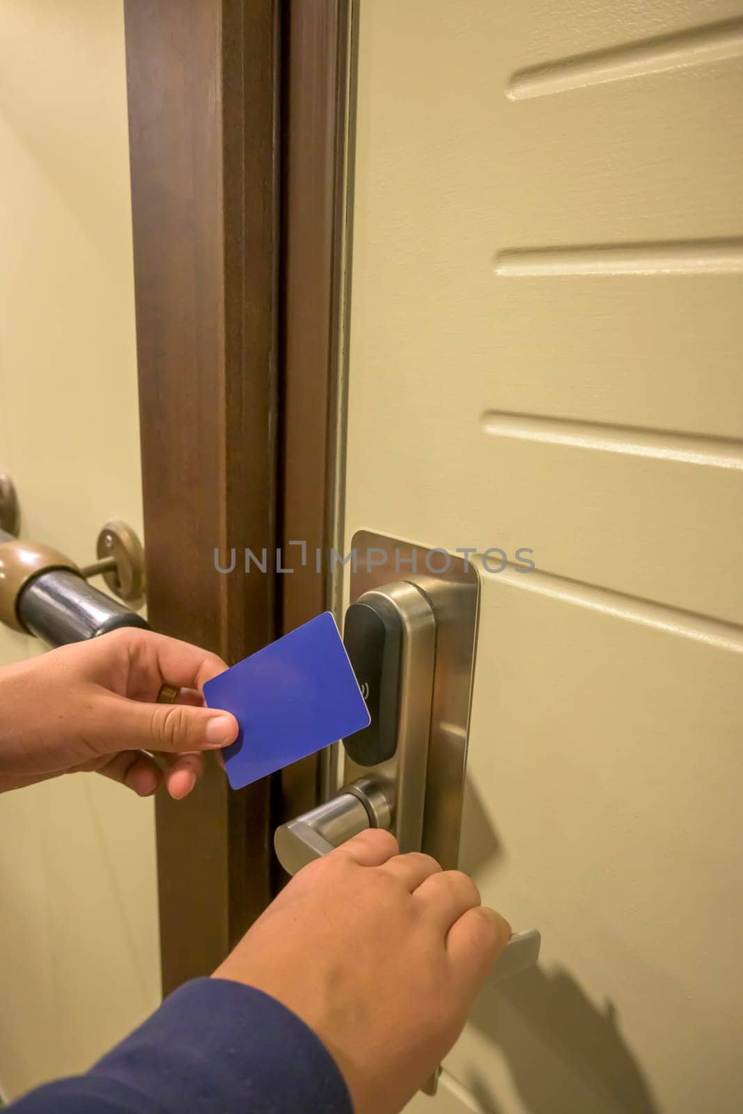 Close-up of a hand using a blue card key in a hotel door lock, key electronic lock, hotel room, holidays in mallorca, spain
