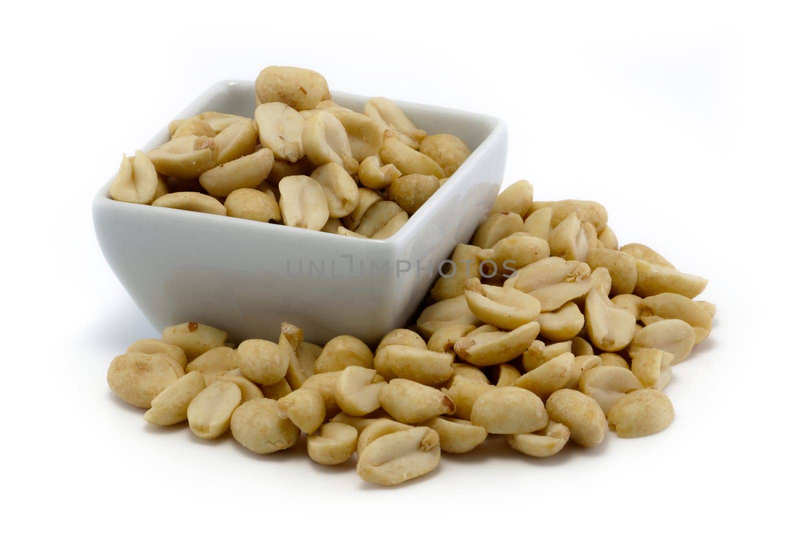 Roasted peanuts in a group isolated on white