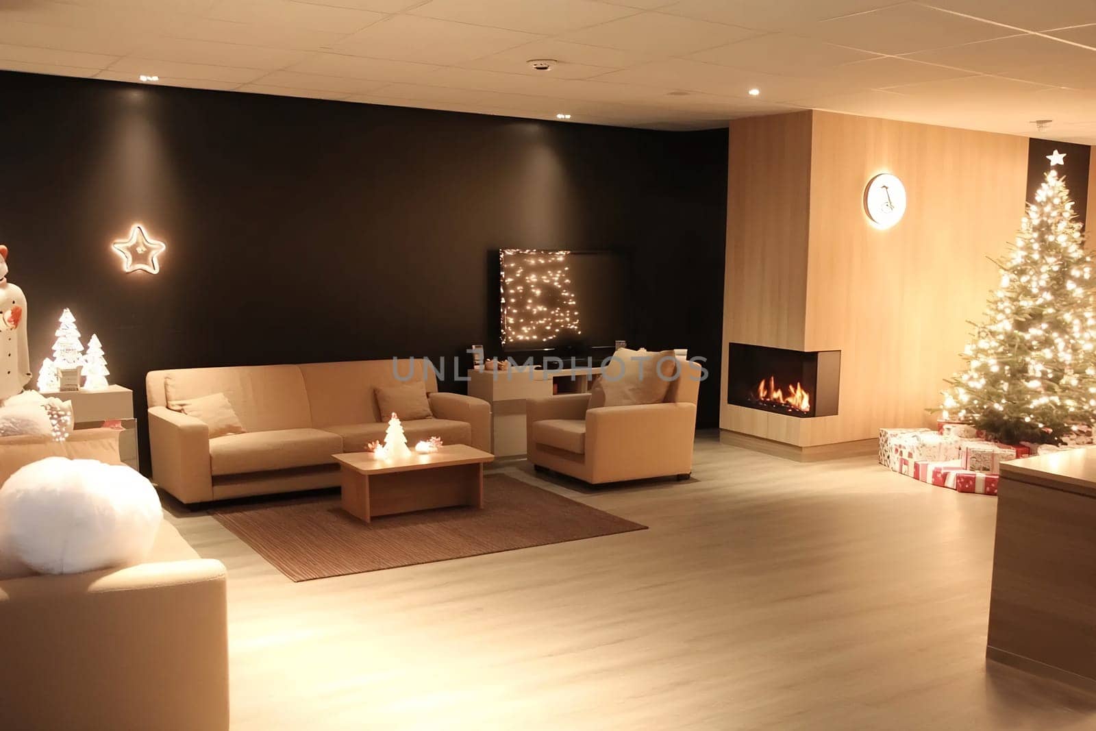A modern living room features a beautifully lit Christmas tree, comfortable seating, and warm decorations creating a festive atmosphere.