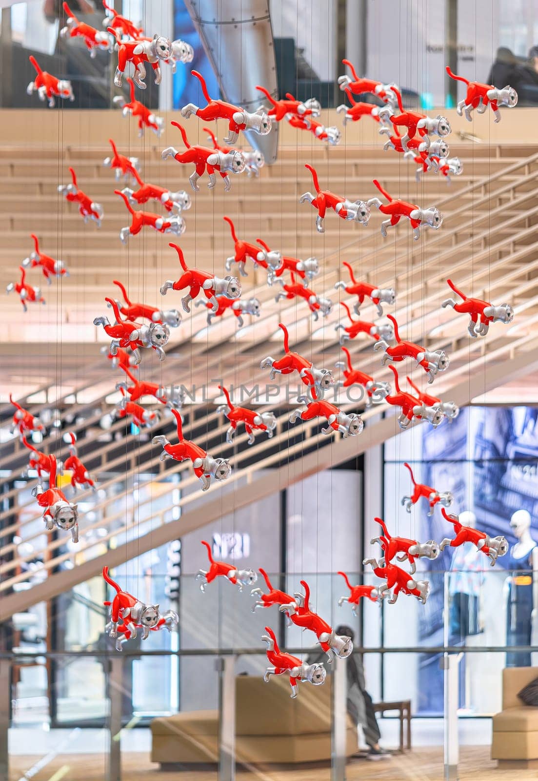 tokyo, japan - may 14 2024: A bunch cats figurines hung in the atrium of the Ginza Six Department Store created by the Japanese Kenji Yanobe part of the Contemporary Art installation BIG CAT BANG.
