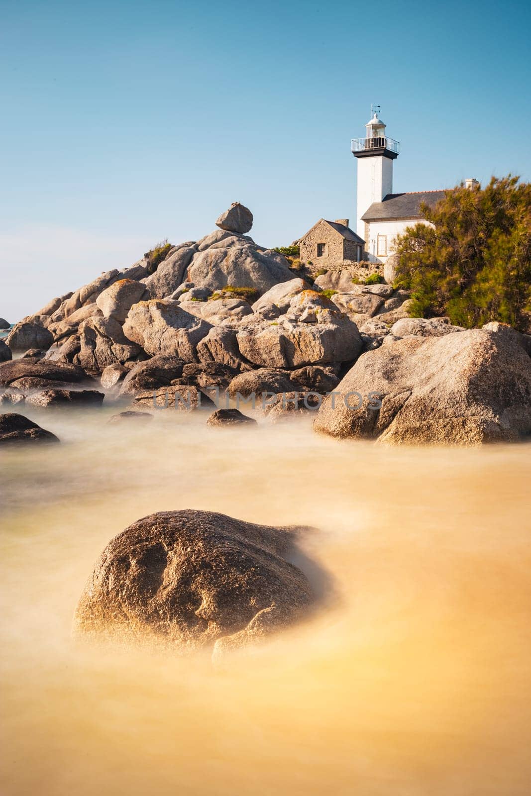 Pontusval lighthouse vertically photographed in long exposure in Kerlouan, northern Brittany, France