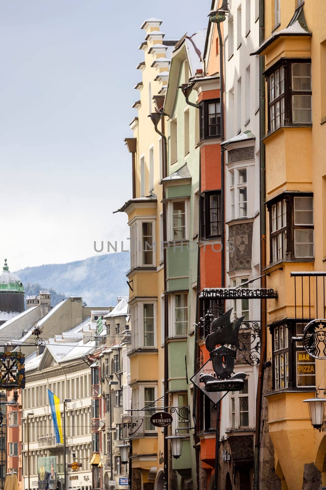 Innsbruck, Austria - February 26, 2023: View of colorful facades of historic tenement houses located on Herzog-Friedrich street