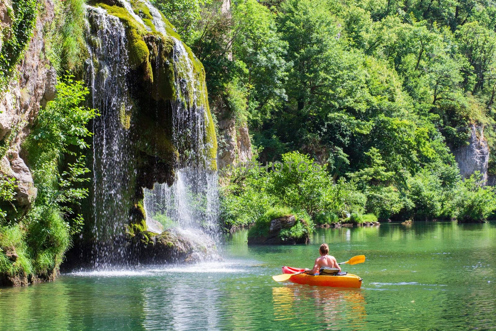 Canoe and cascade near Castelbouc village in the valley of the Tarn river, french canyon