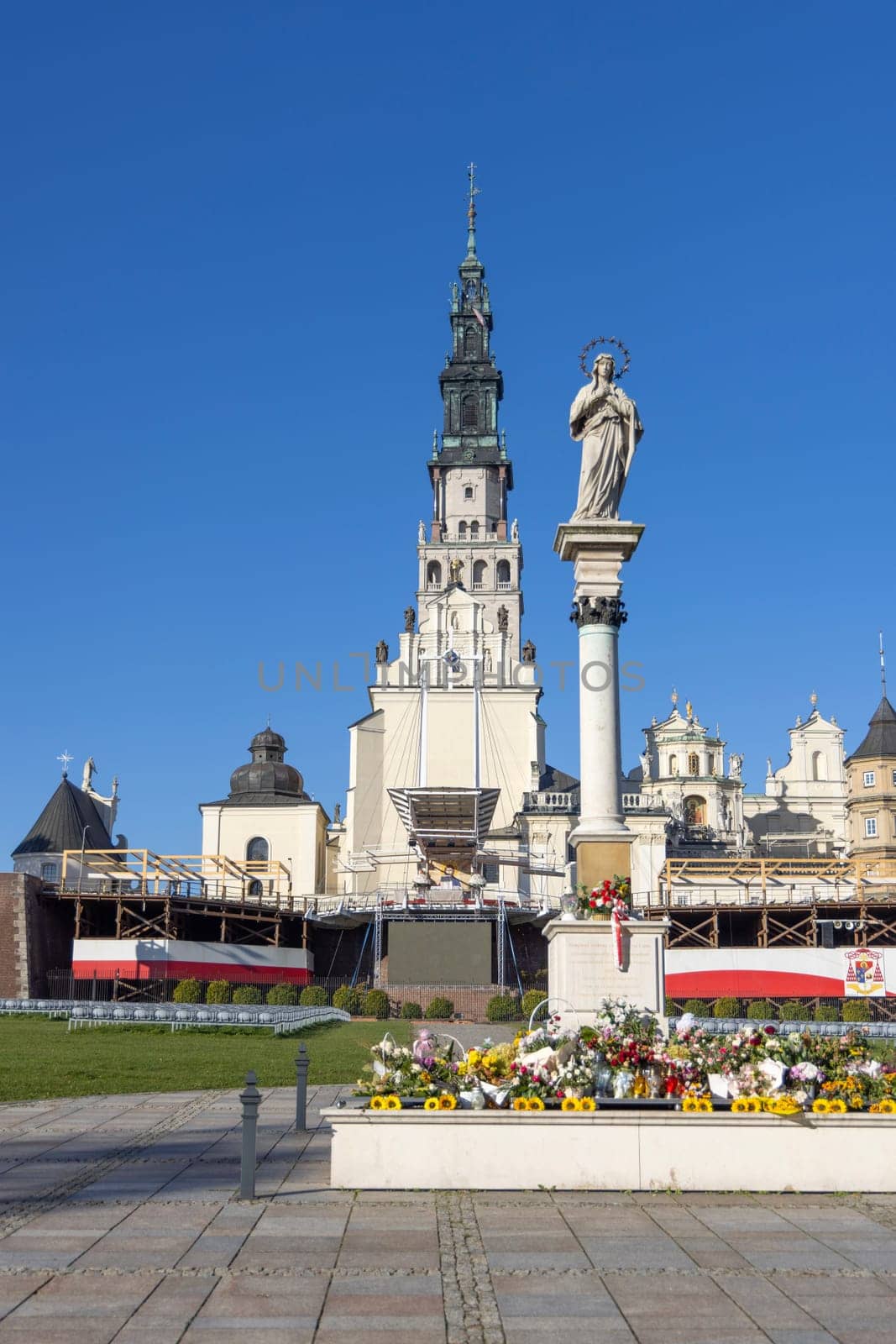 Czestochowa, Poland - October 18, 2024: Column witch monument to Our Lady Immaculate in front of Jasna Gora Basilica. Altar on the Janogorski Walls with Polish flag