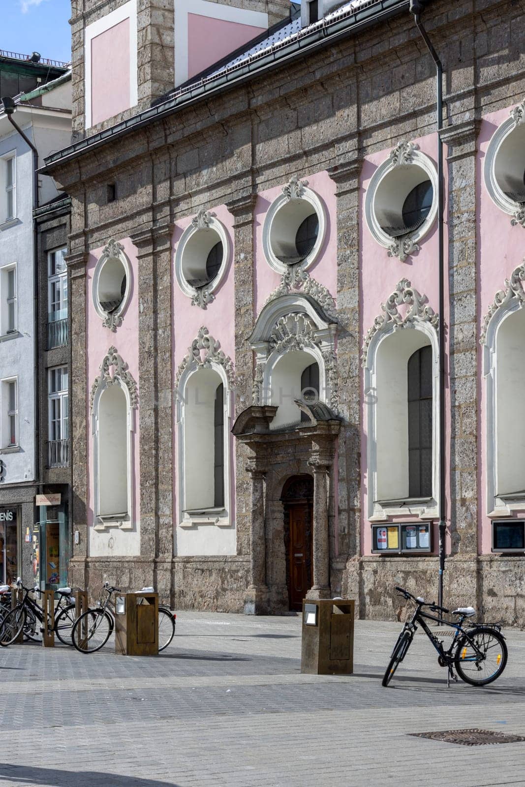 Innsbruck, Austria - February 26, 2023: Decorative facade and portal of Hospital Church of the Holy Spirit on Maria Theresa Street (Maria Theresa Strasse)